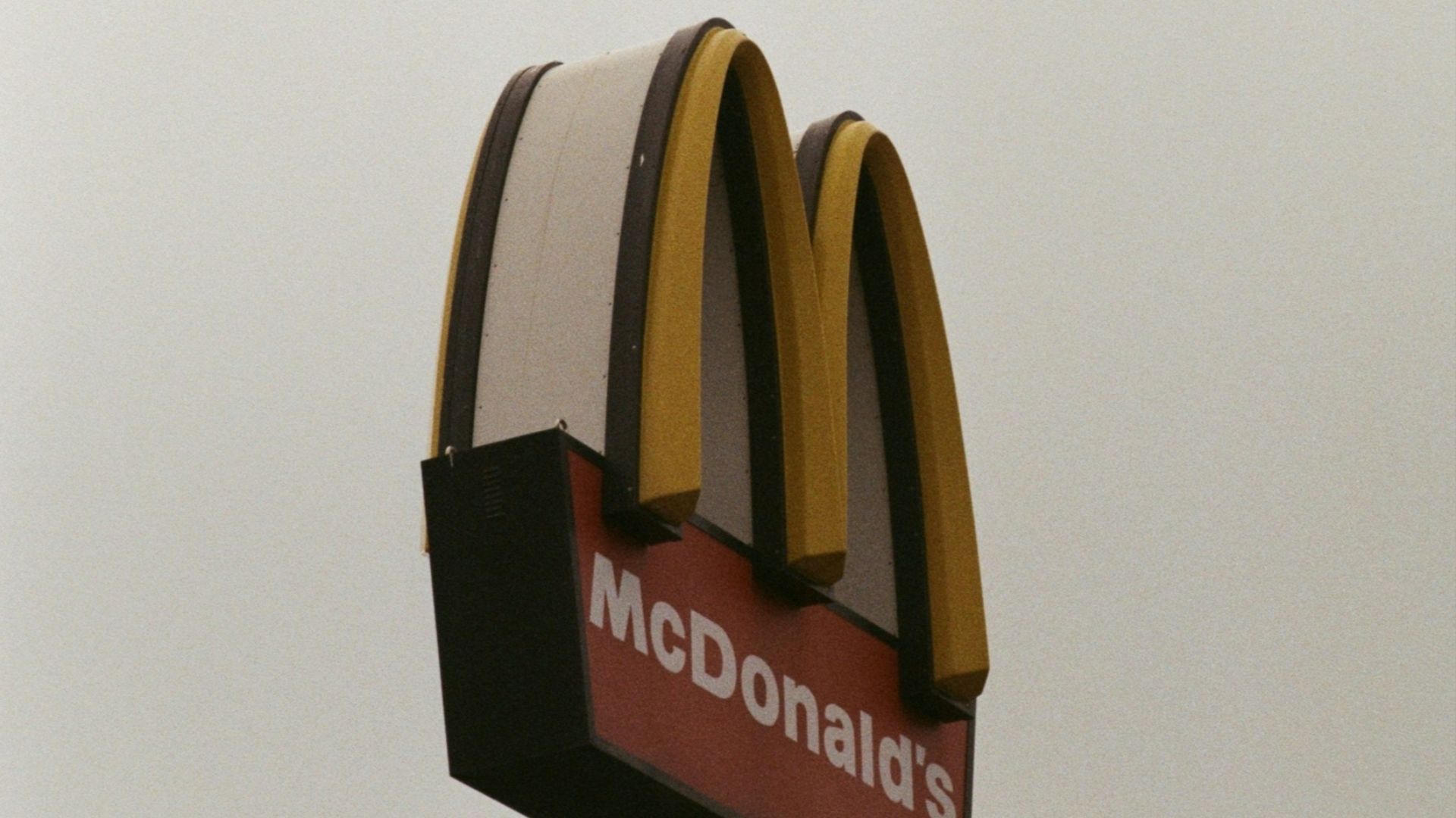 a mcdonald's sign with a sky background