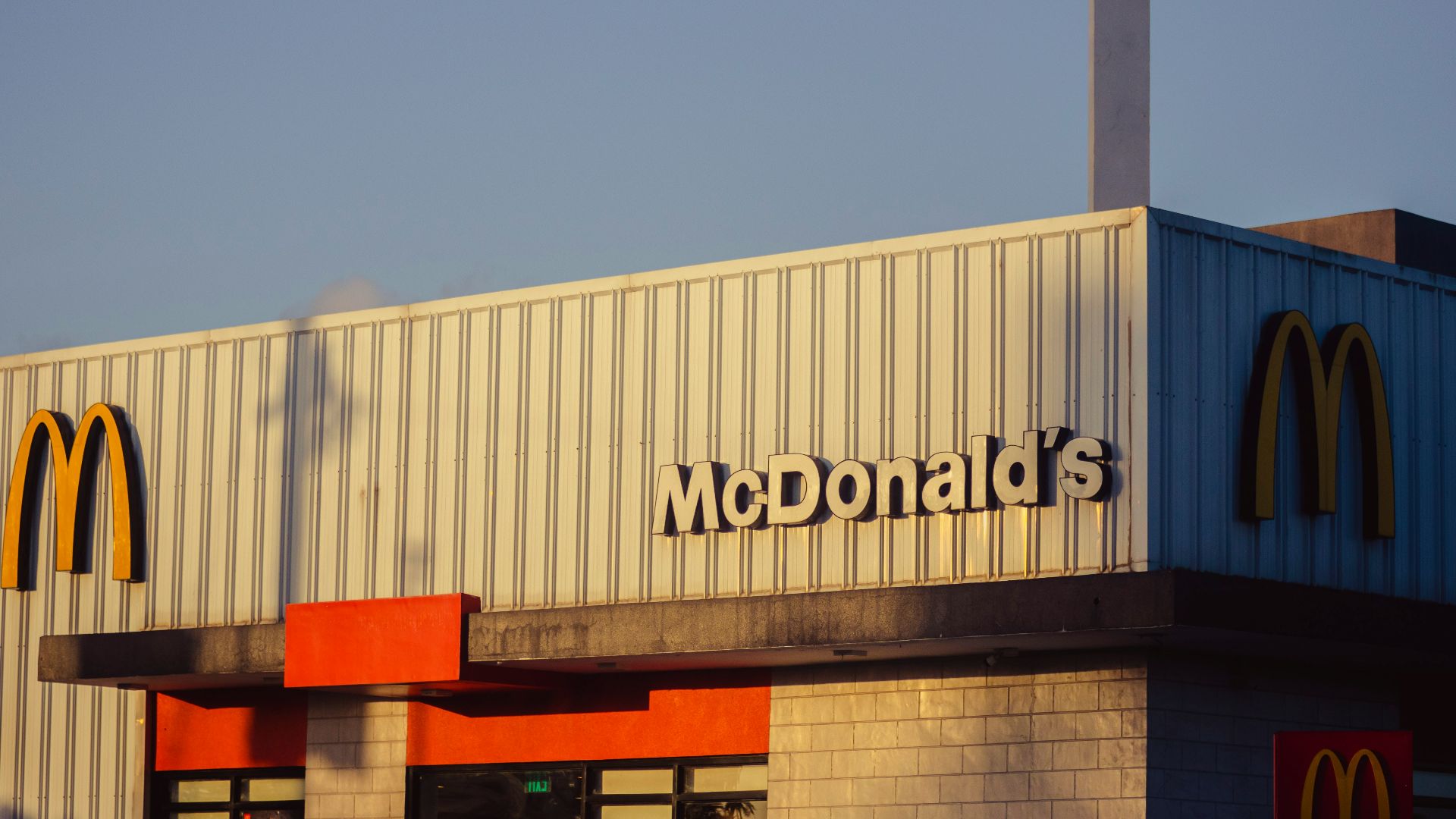 a mcdonald's restaurant with a smoke stack sticking out of the roof