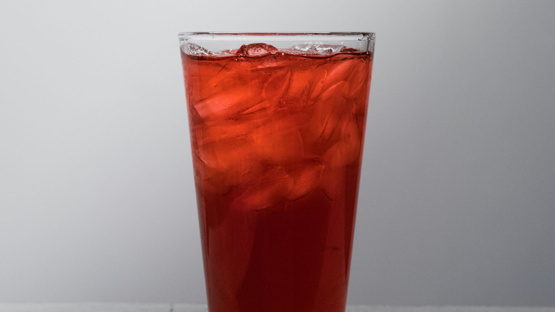 clear drinking glass with brown liquid