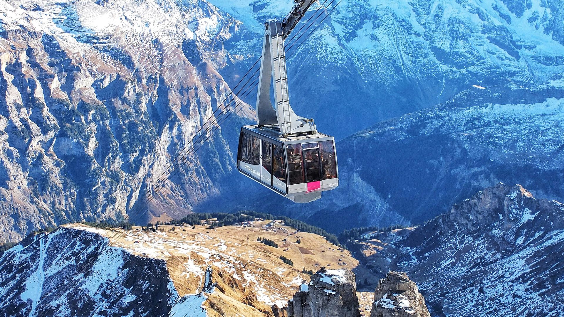 bird's eye view of ski lift over mountains during winter