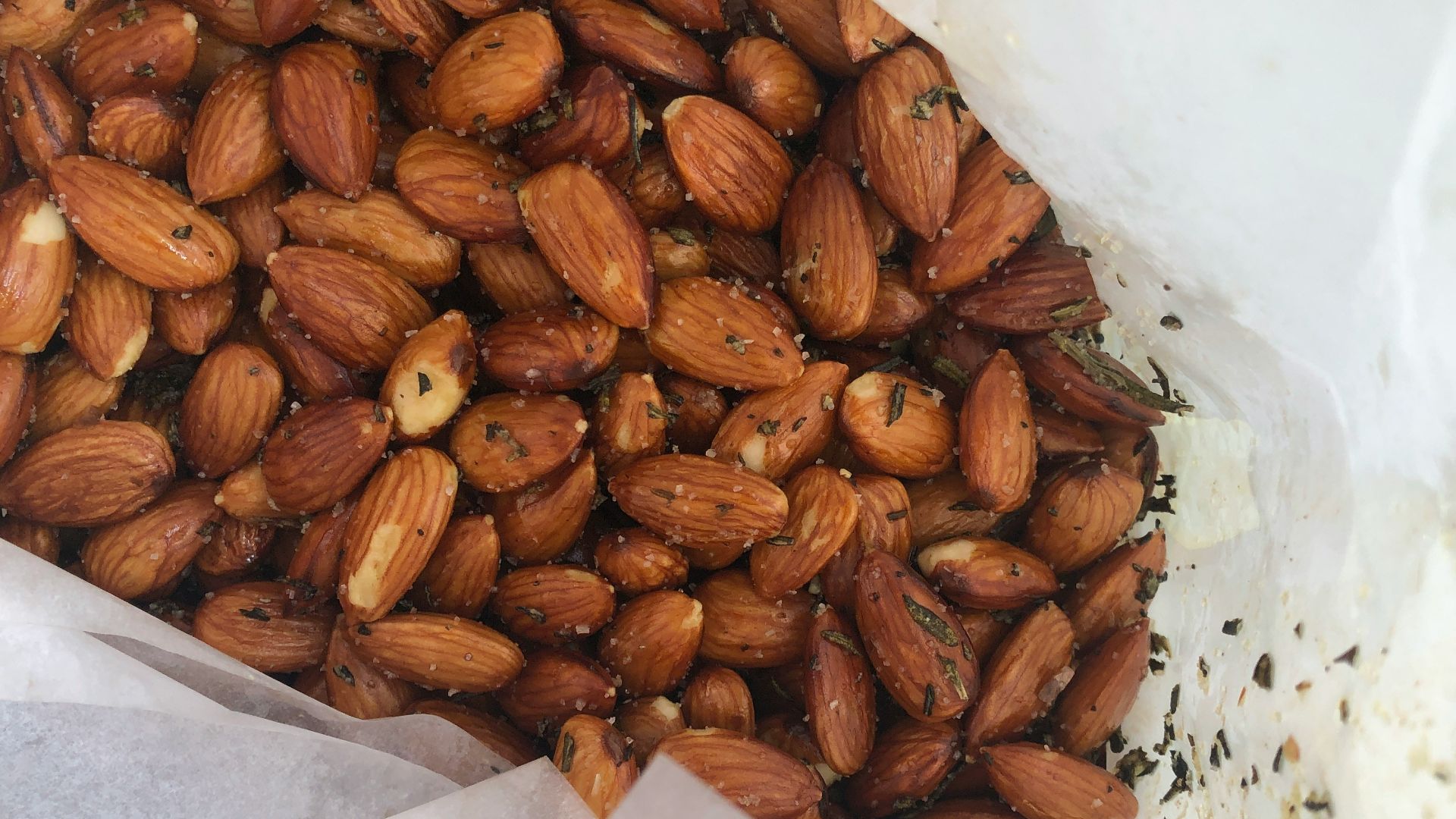 a pile of nuts sitting on top of a white bag