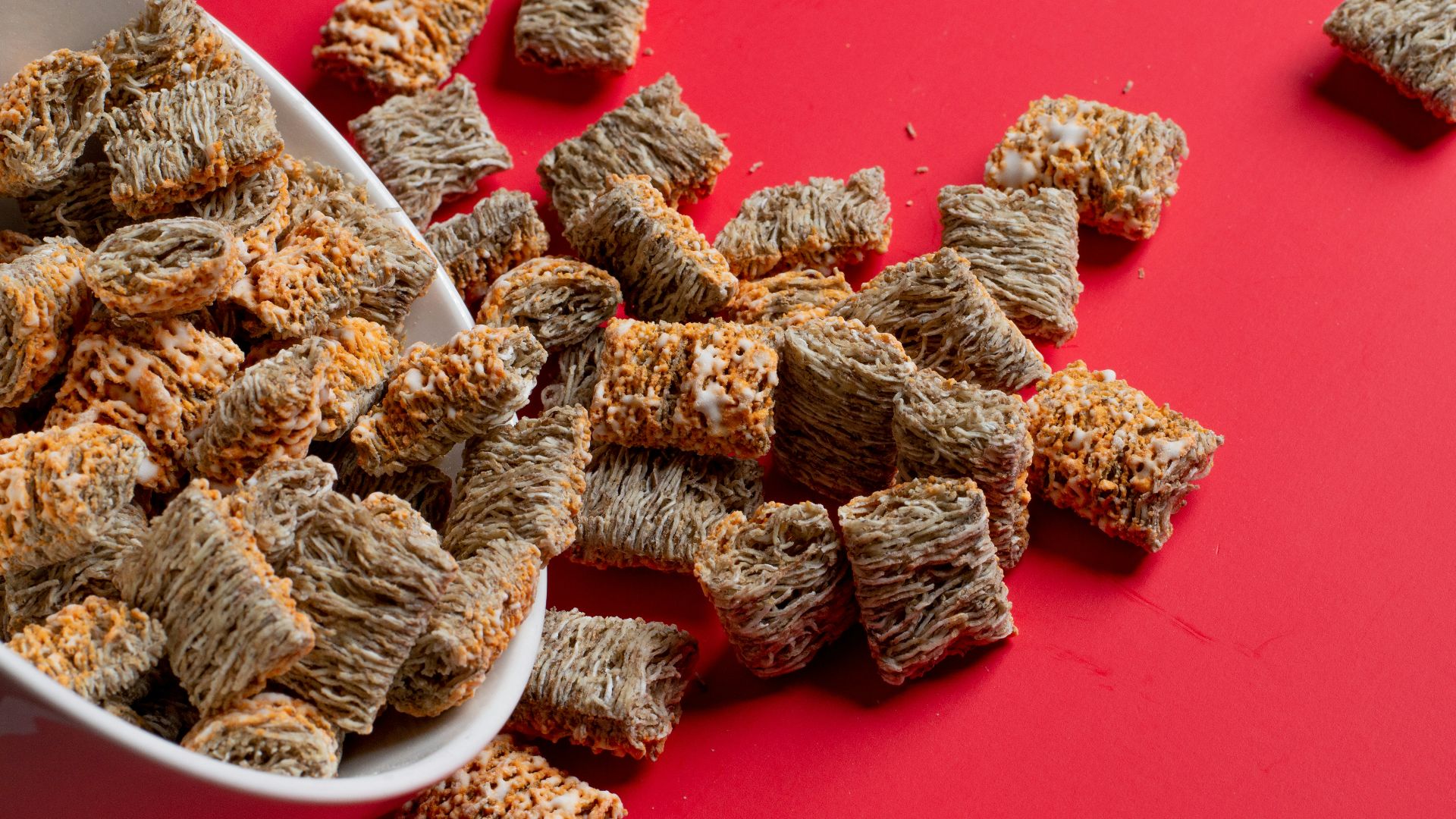 a bowl full of dog treats on a red surface
