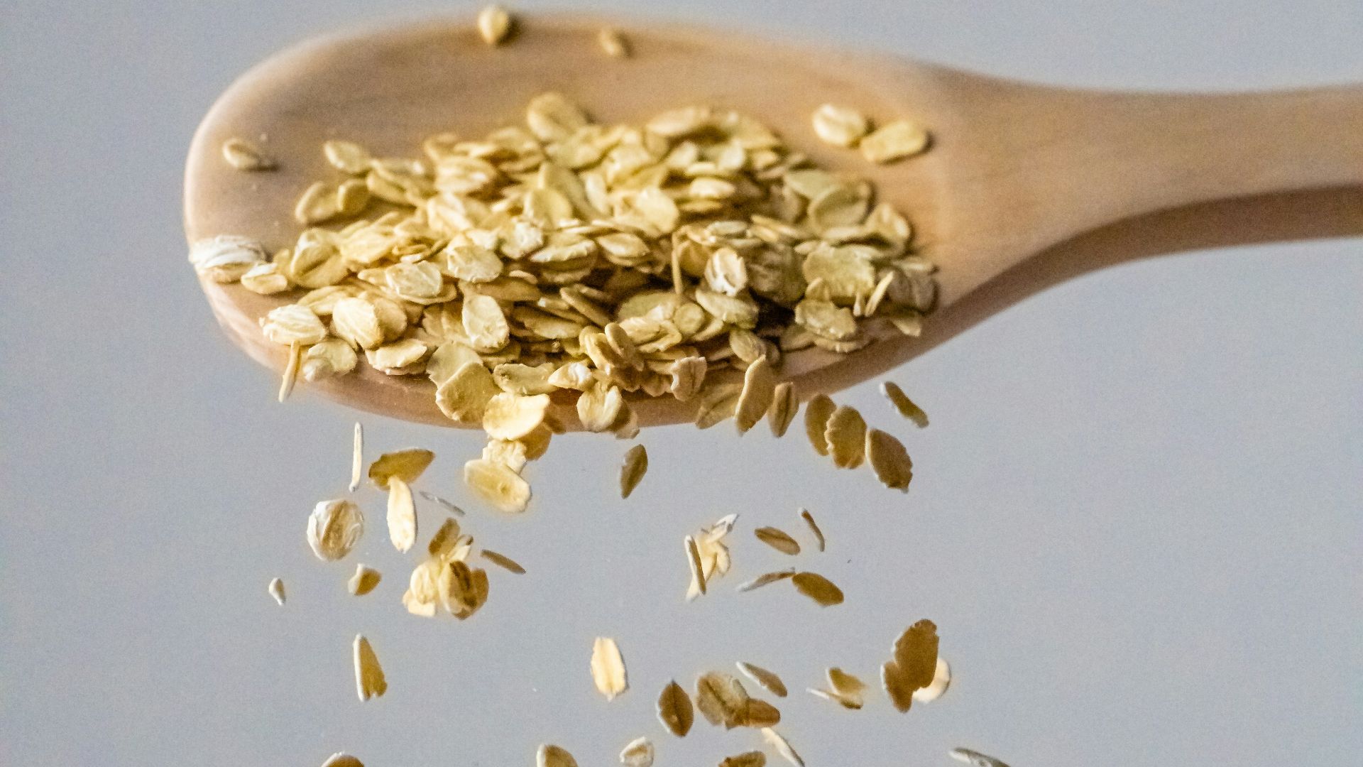 a wooden spoon filled with gold flakes