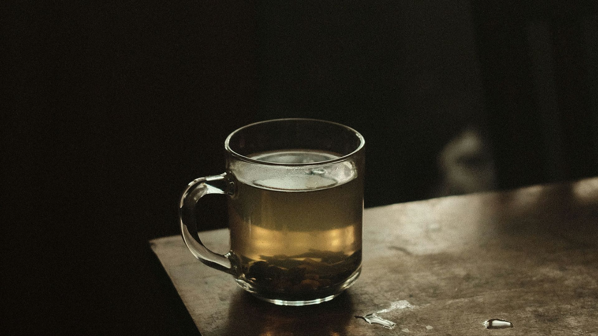 clear glass mug with brown liquid