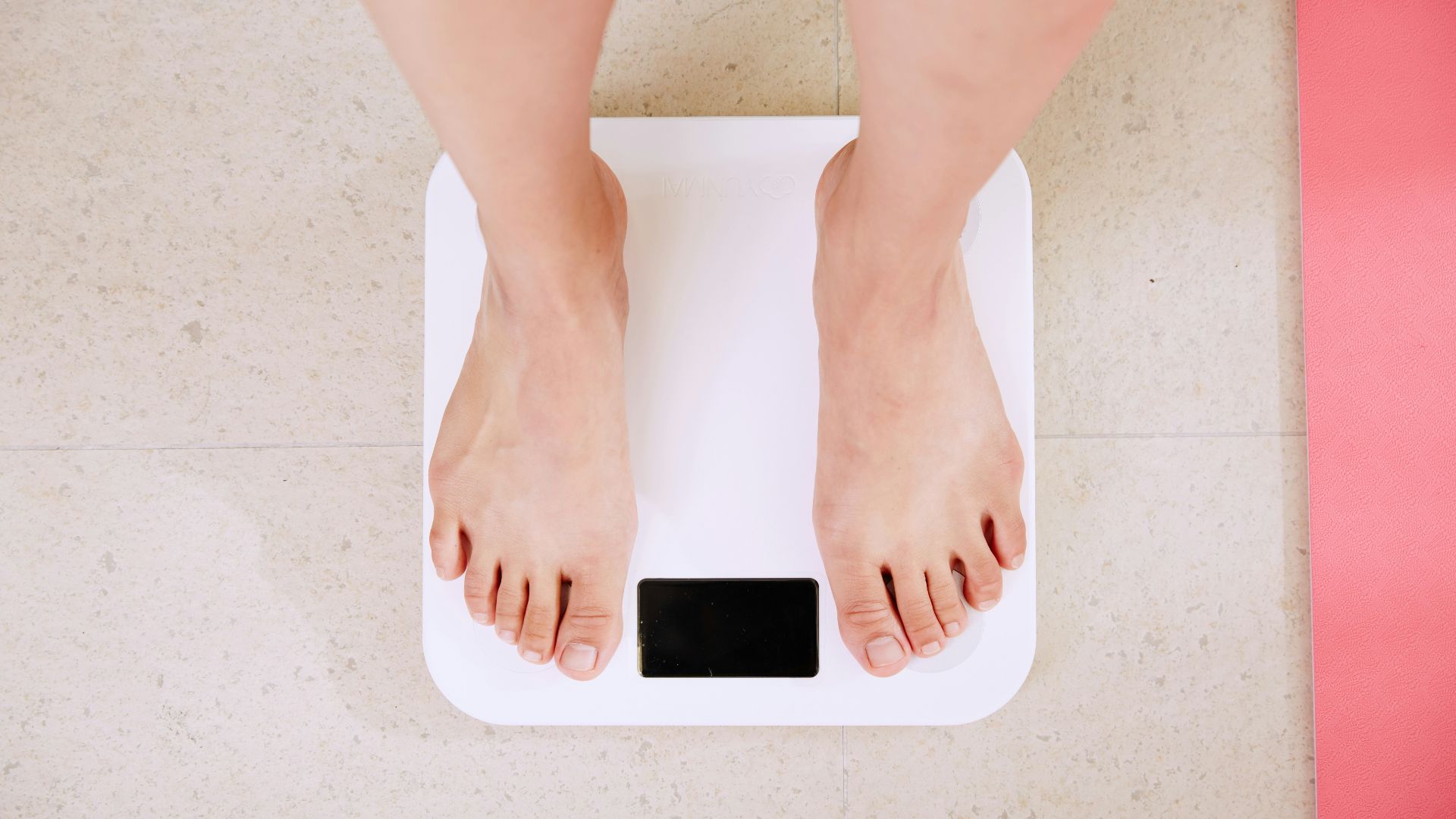 person standing on white digital bathroom scale