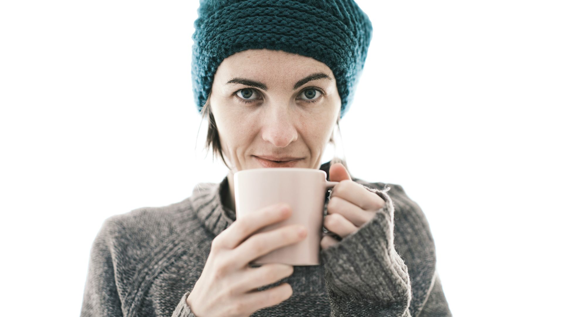 a woman is holding a cup of coffee