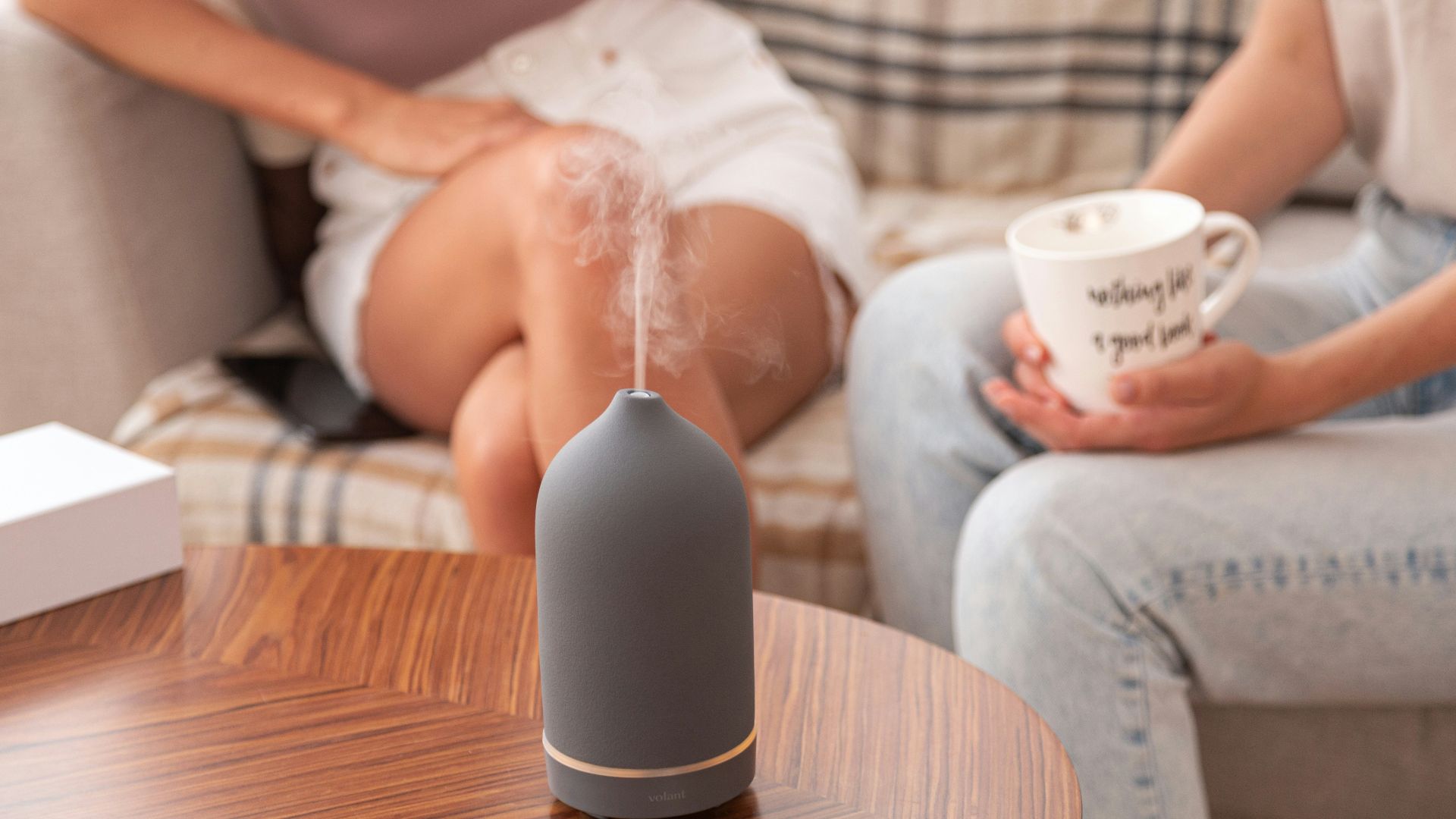 a person sitting at a table with a cup of coffee
