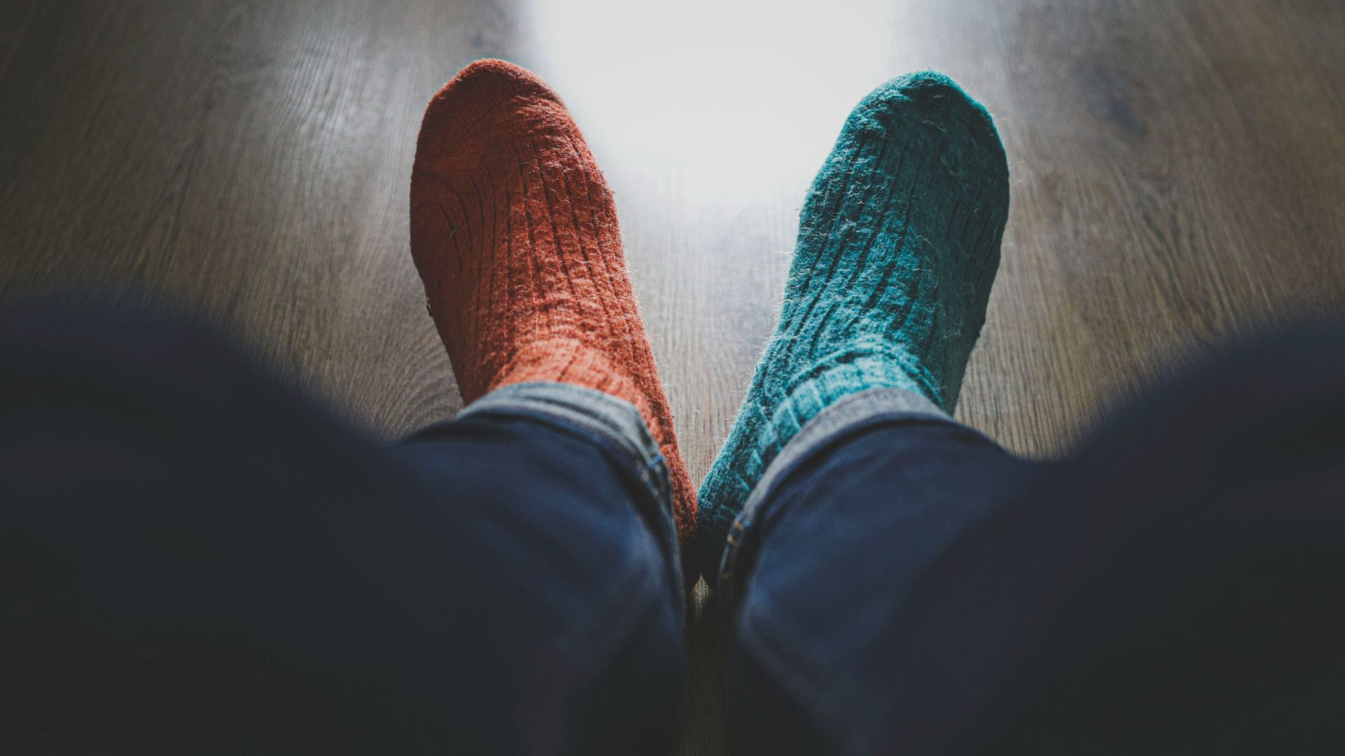 person wearing blue denim jeans and red socks