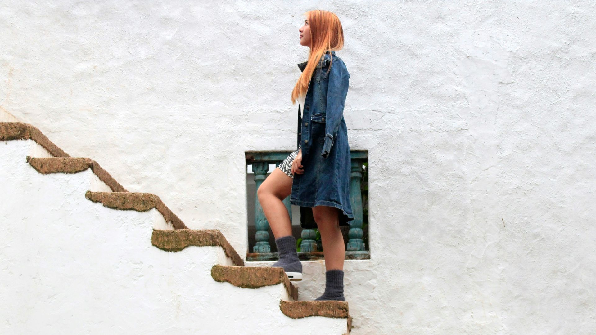 woman climbing on brown concrete stairs