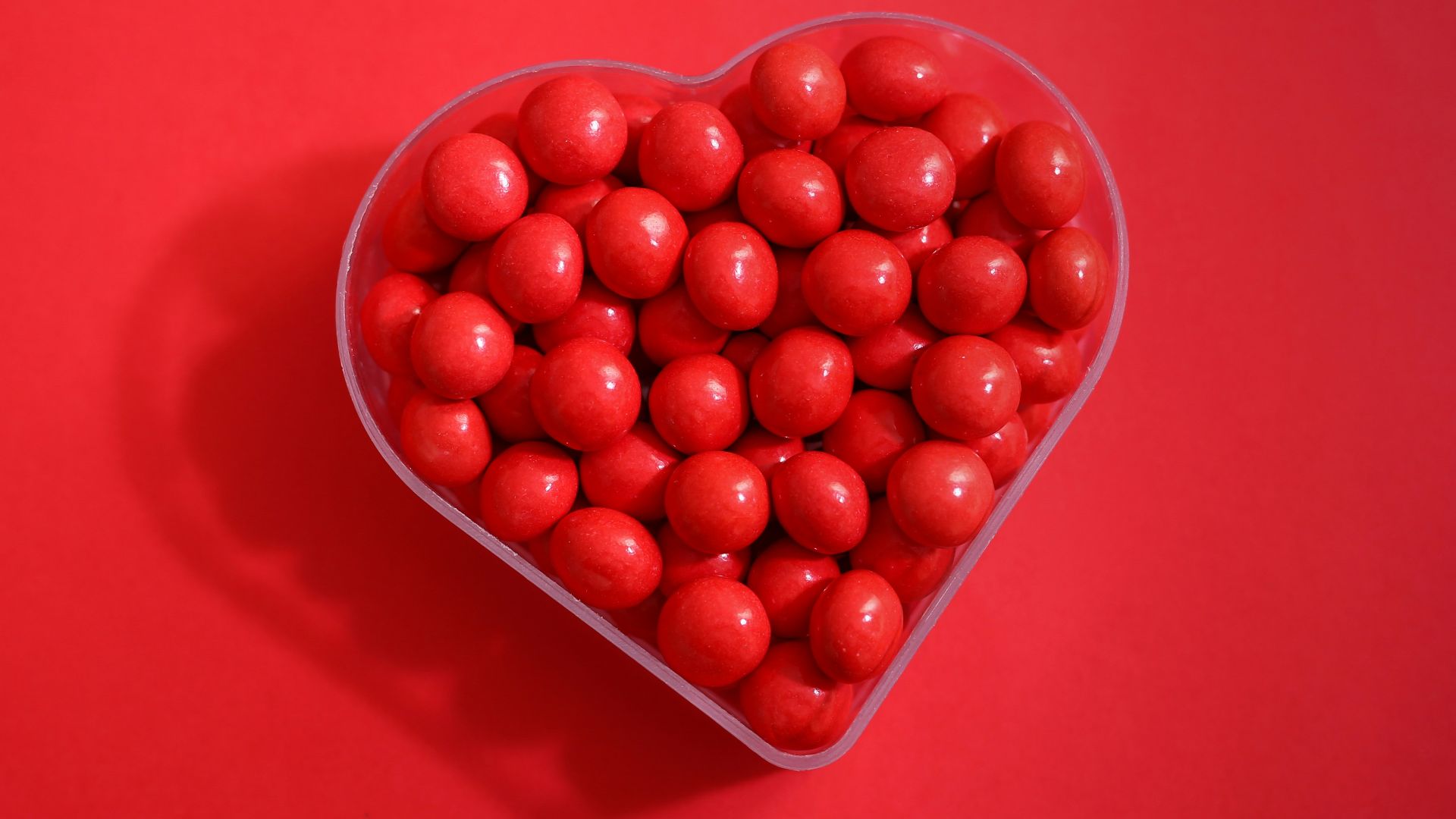 red round fruits on red plastic container
