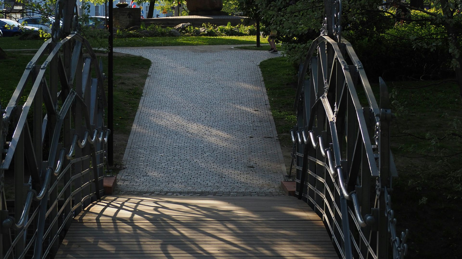 a walkway leading to a park with lots of trees