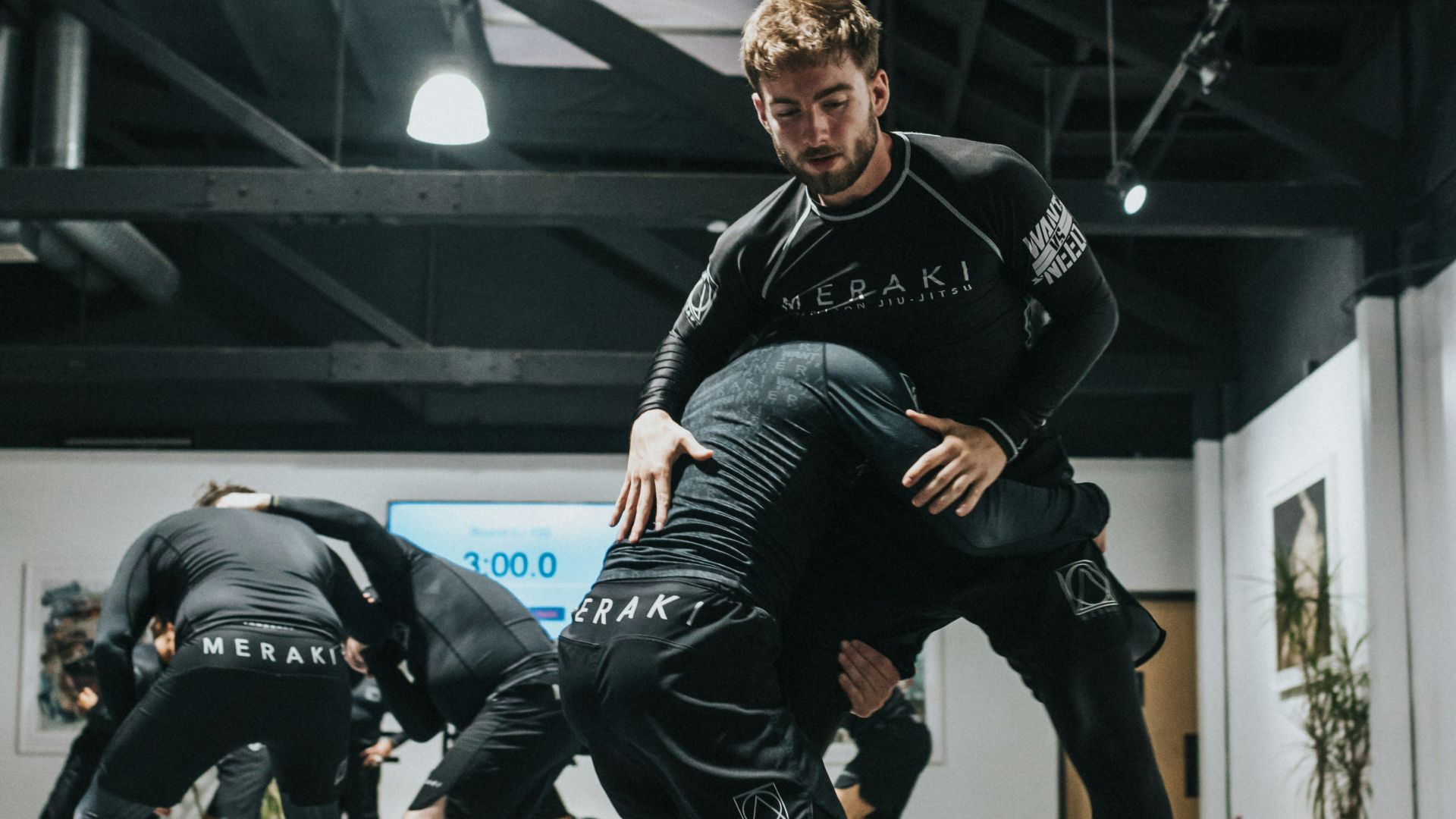 woman in black and white long sleeve shirt and black shorts running on gray concrete floor
