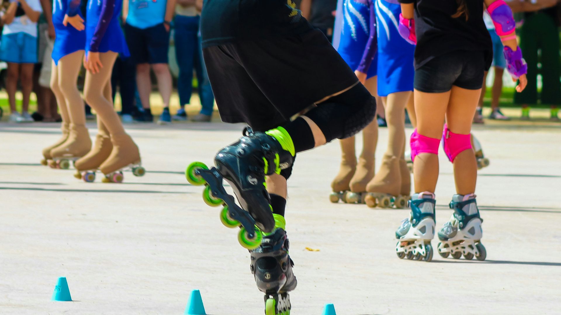 a man riding a skateboard down a street next to cones