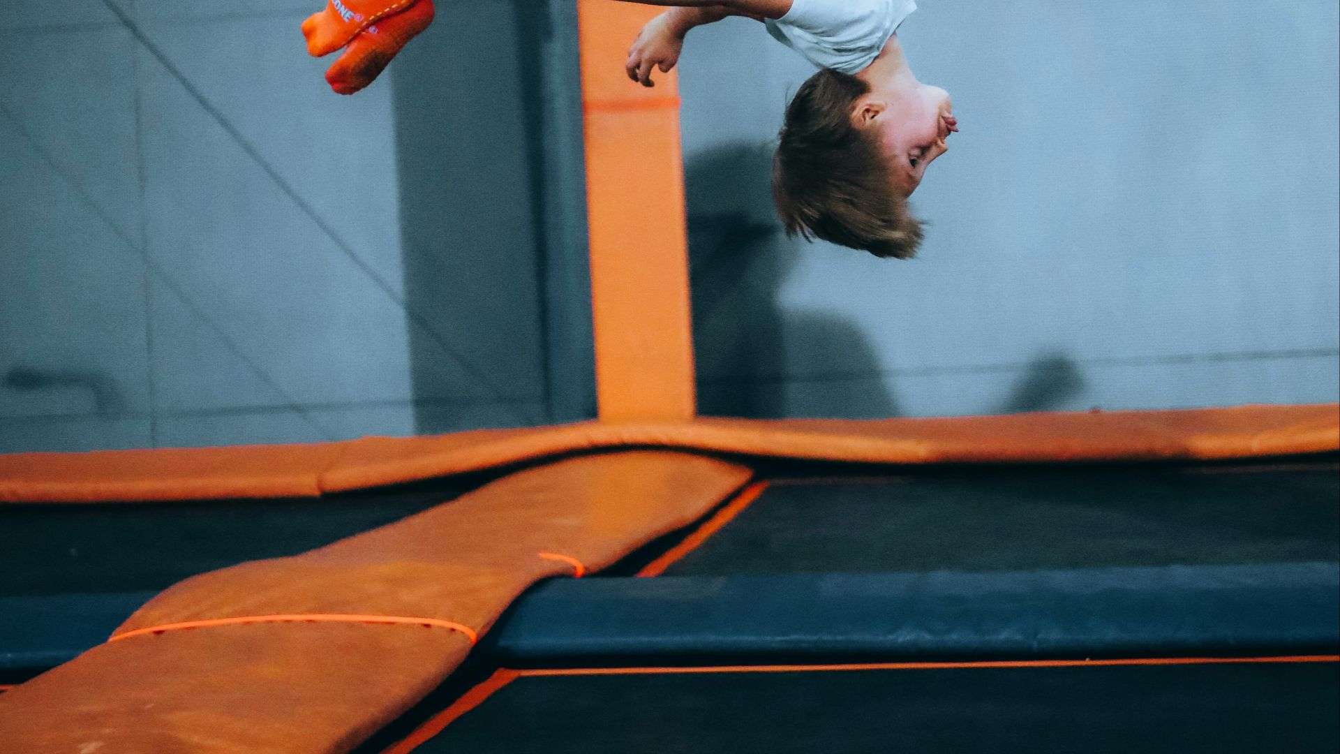 a man is doing a trick on a trampoline