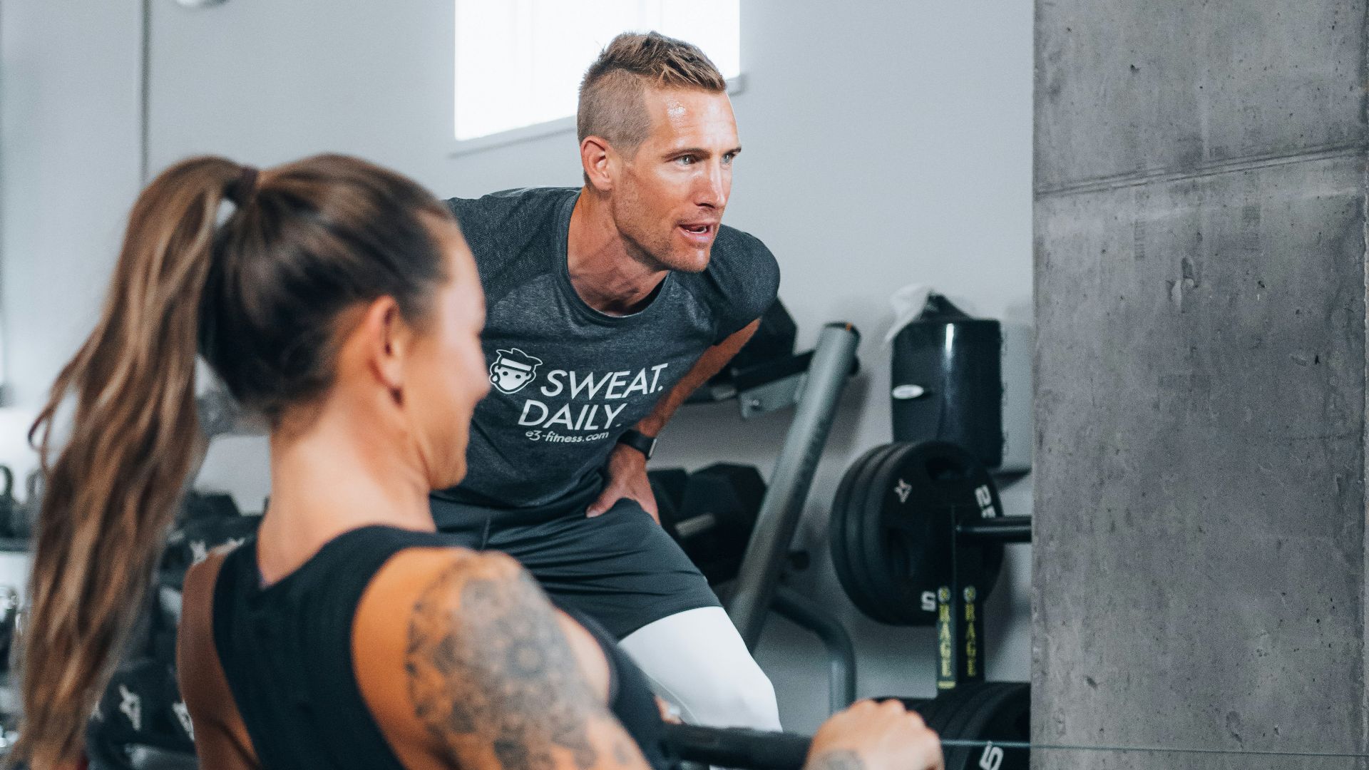a man and a woman working out in a gym