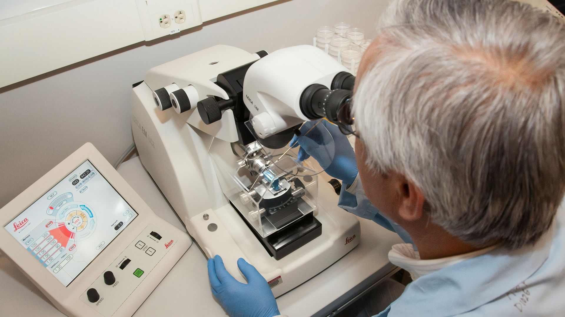man in white shirt using white sewing machine