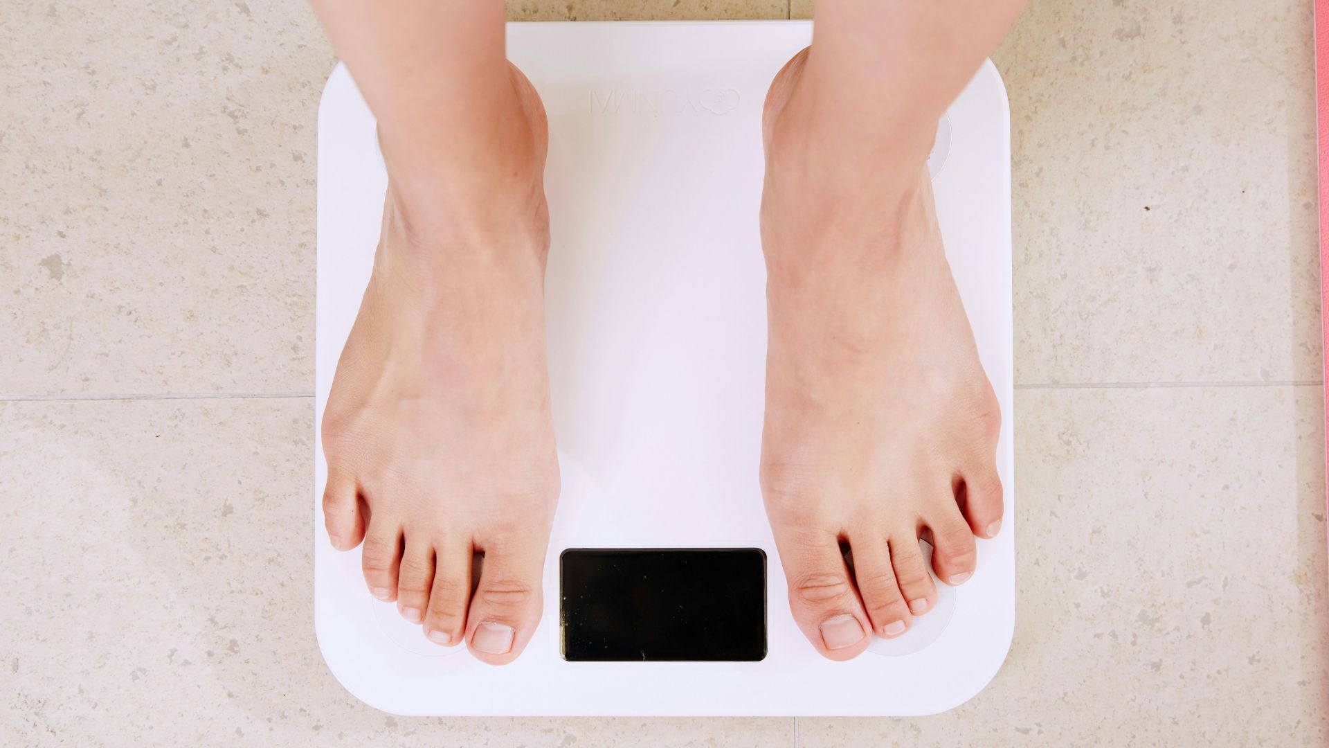 person standing on white digital bathroom scale