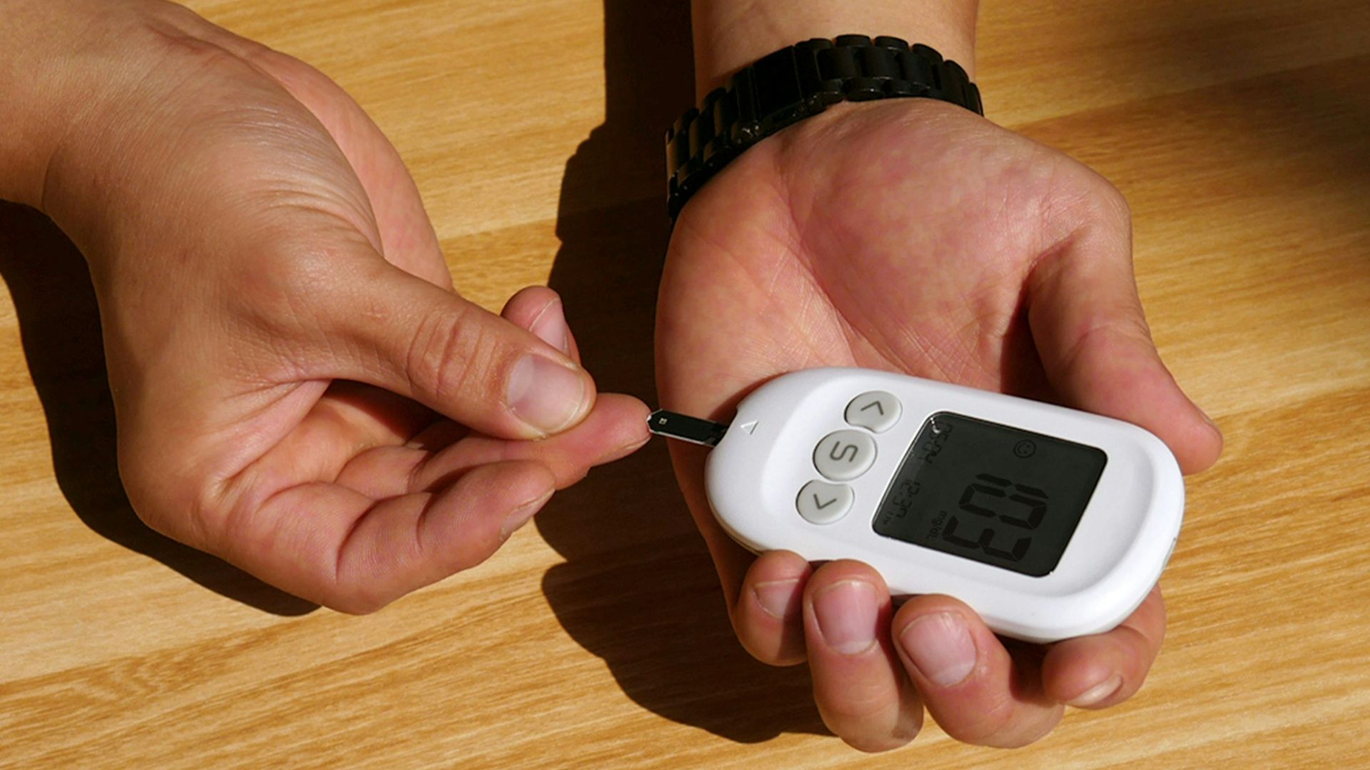 a person holding a remote control in their hand