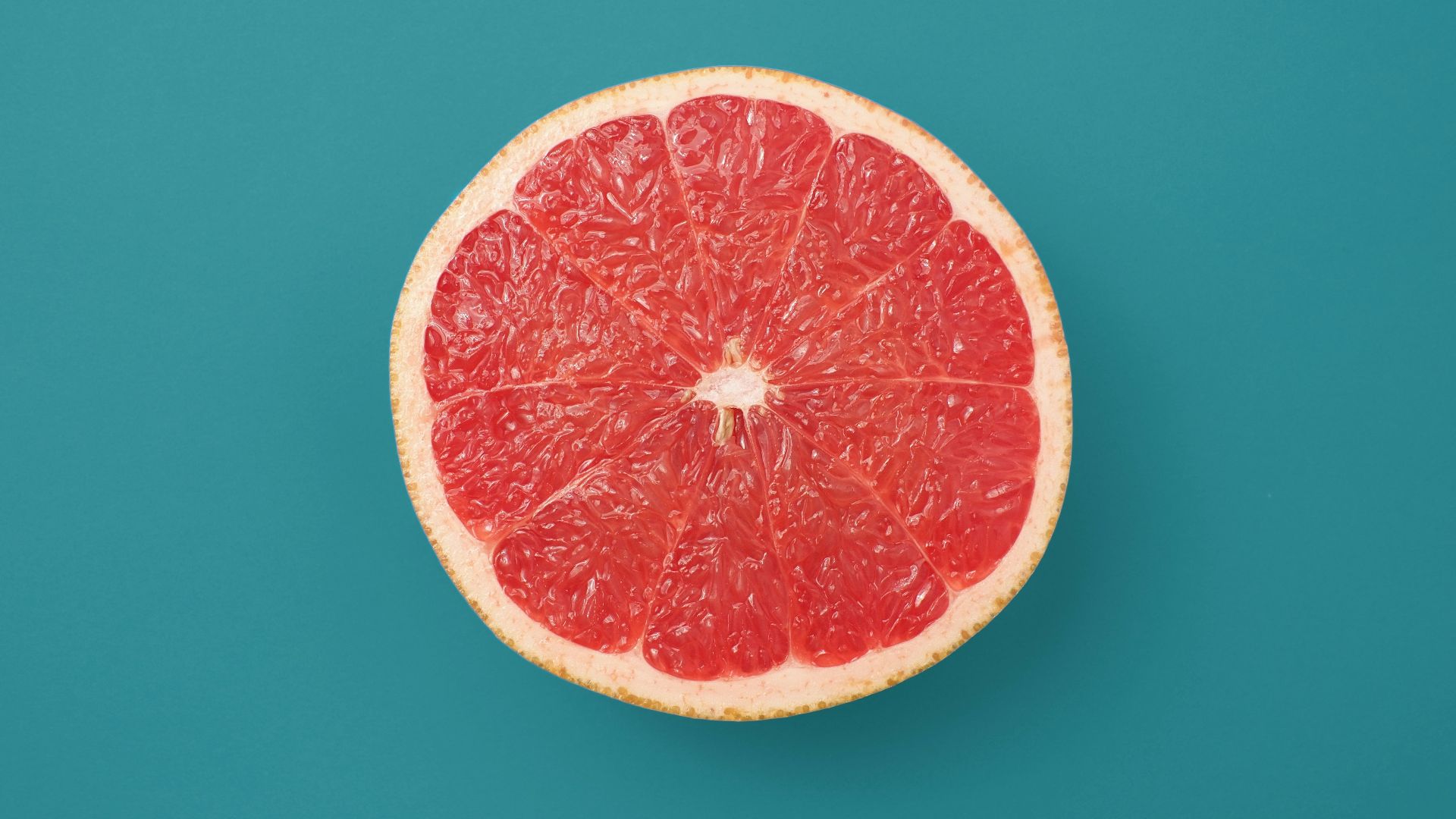 sliced orange fruit on blue background