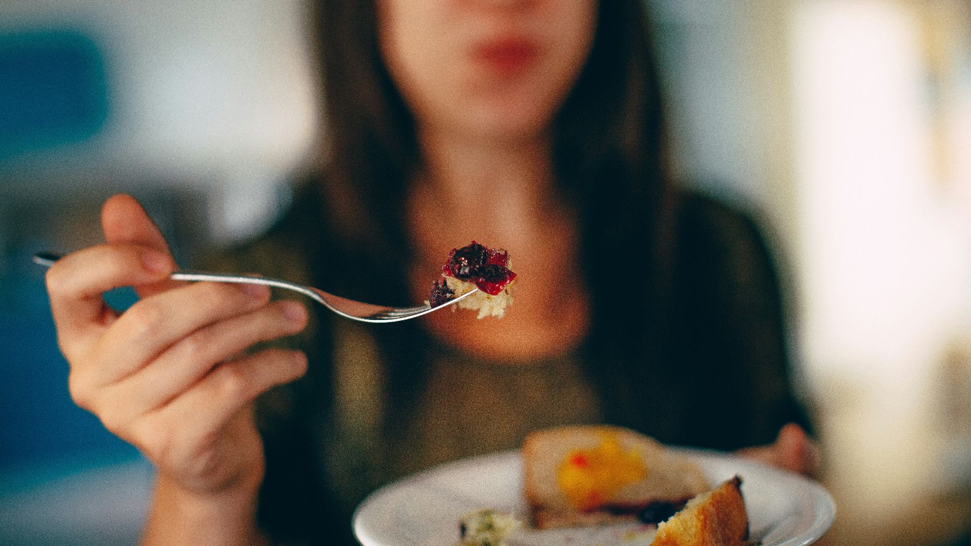 woman holding plate of cake