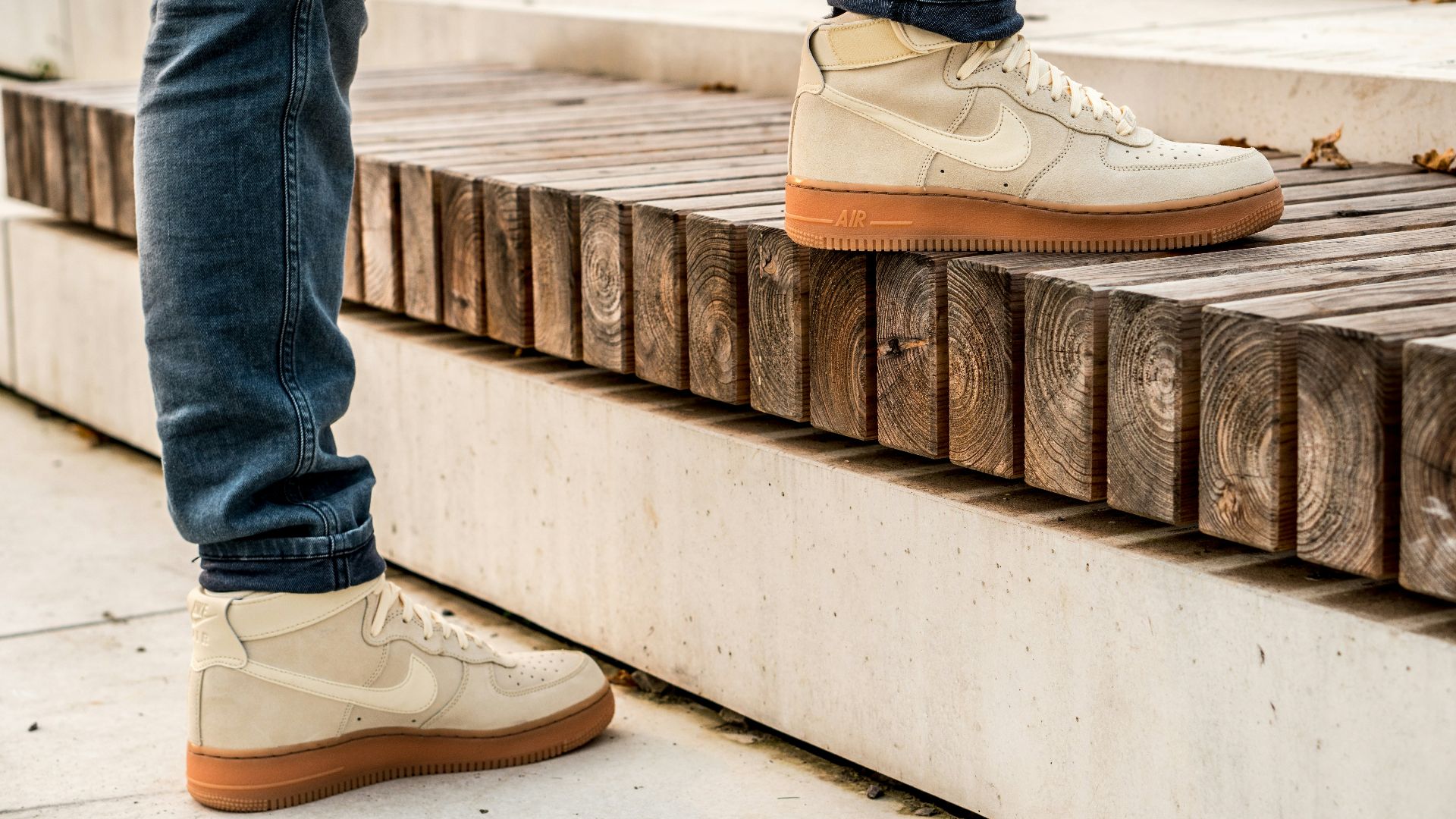 person in blue denim jeans wearing white nike sneakers