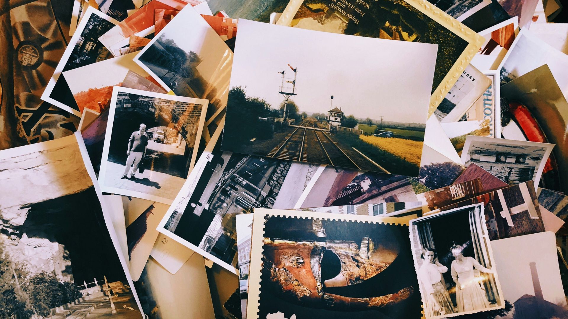a pile of old photos and postcards sitting on top of each other