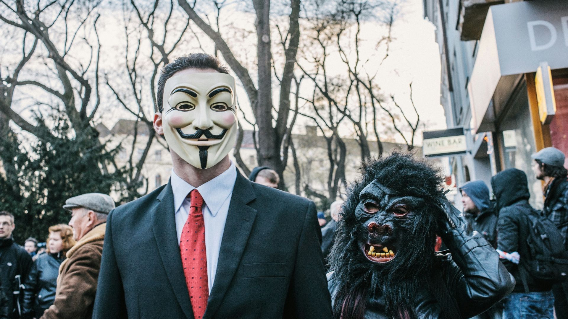 man in black suit jacket wearing black and white mask