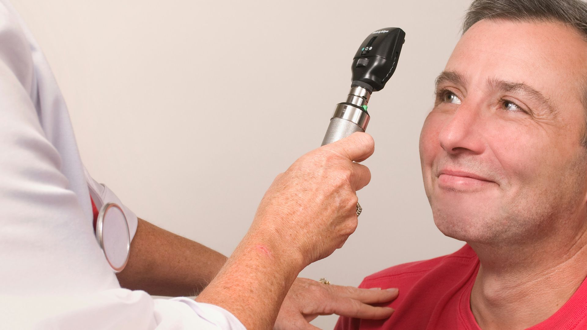 a man getting his teeth brushed by a doctor