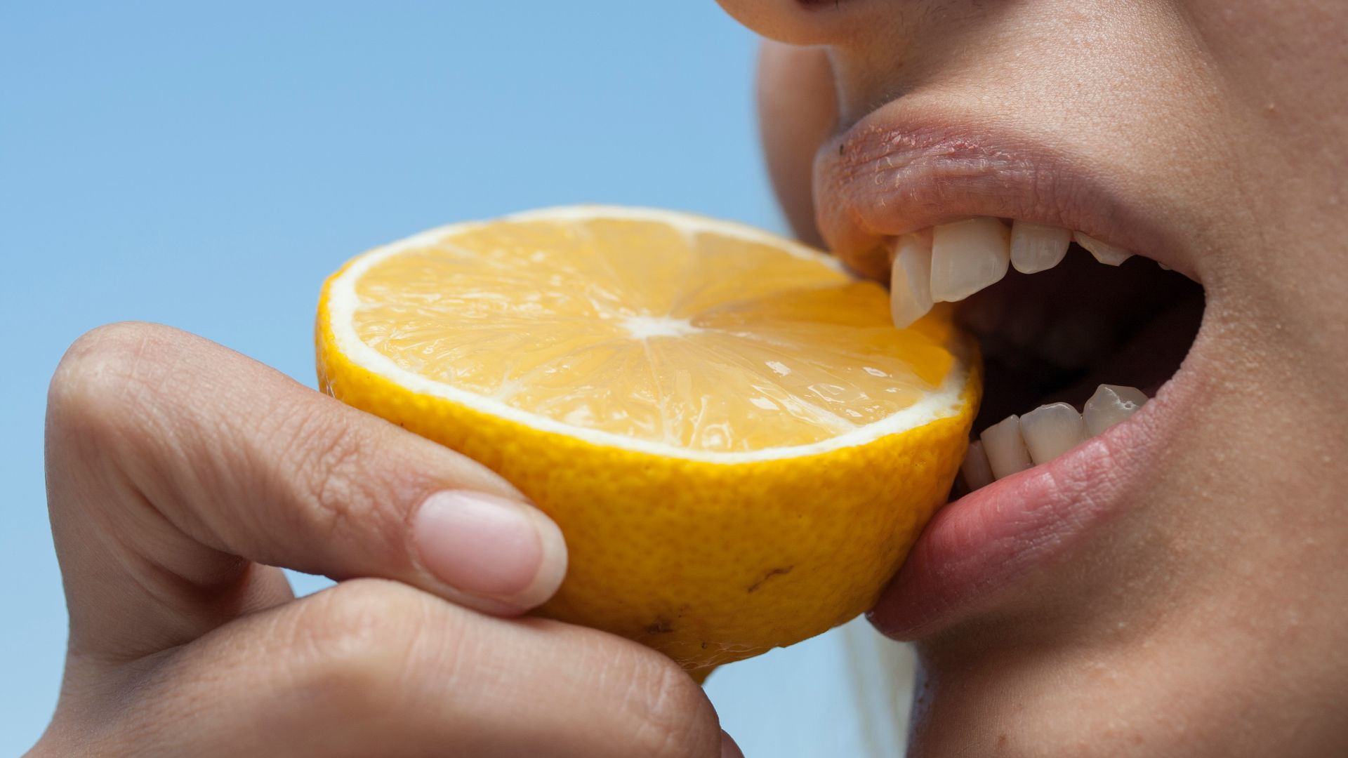 person holding orange fruit during daytime
