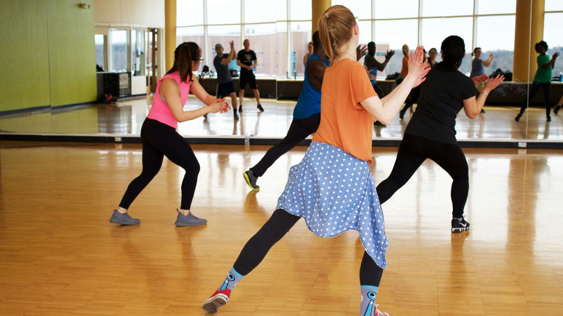 women dancing near mirror