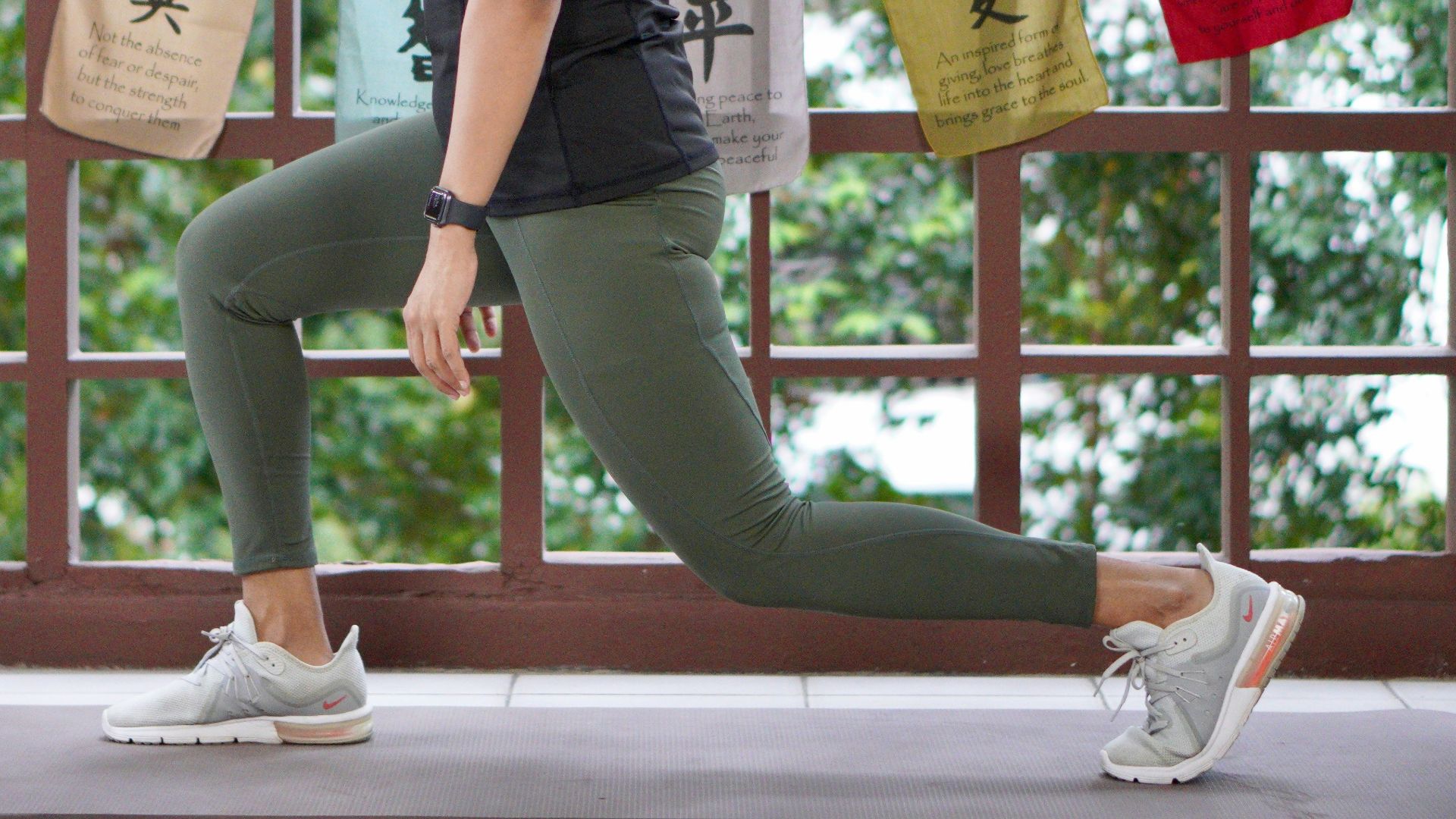 a woman in a black shirt is doing yoga