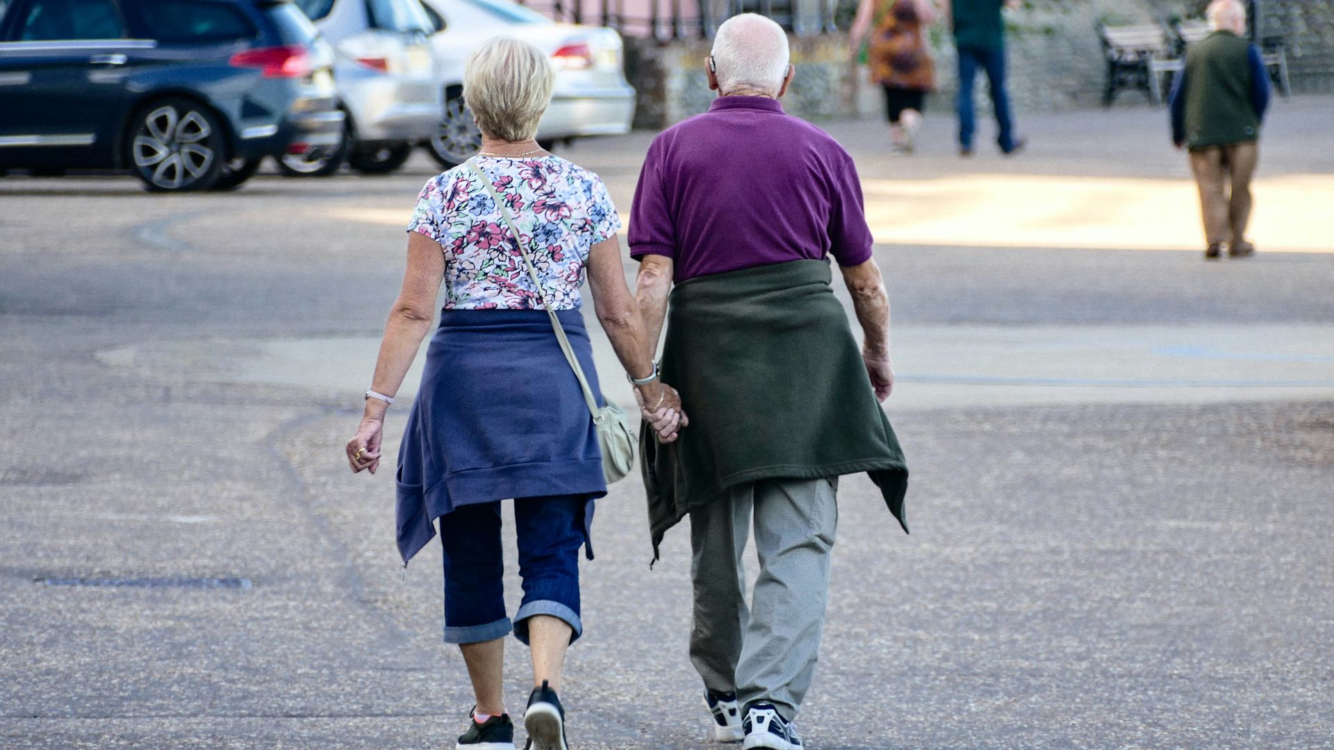 man and woman walking on the street during daytime