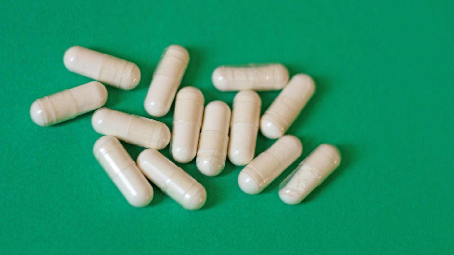 A pile of pills sitting on top of a green table