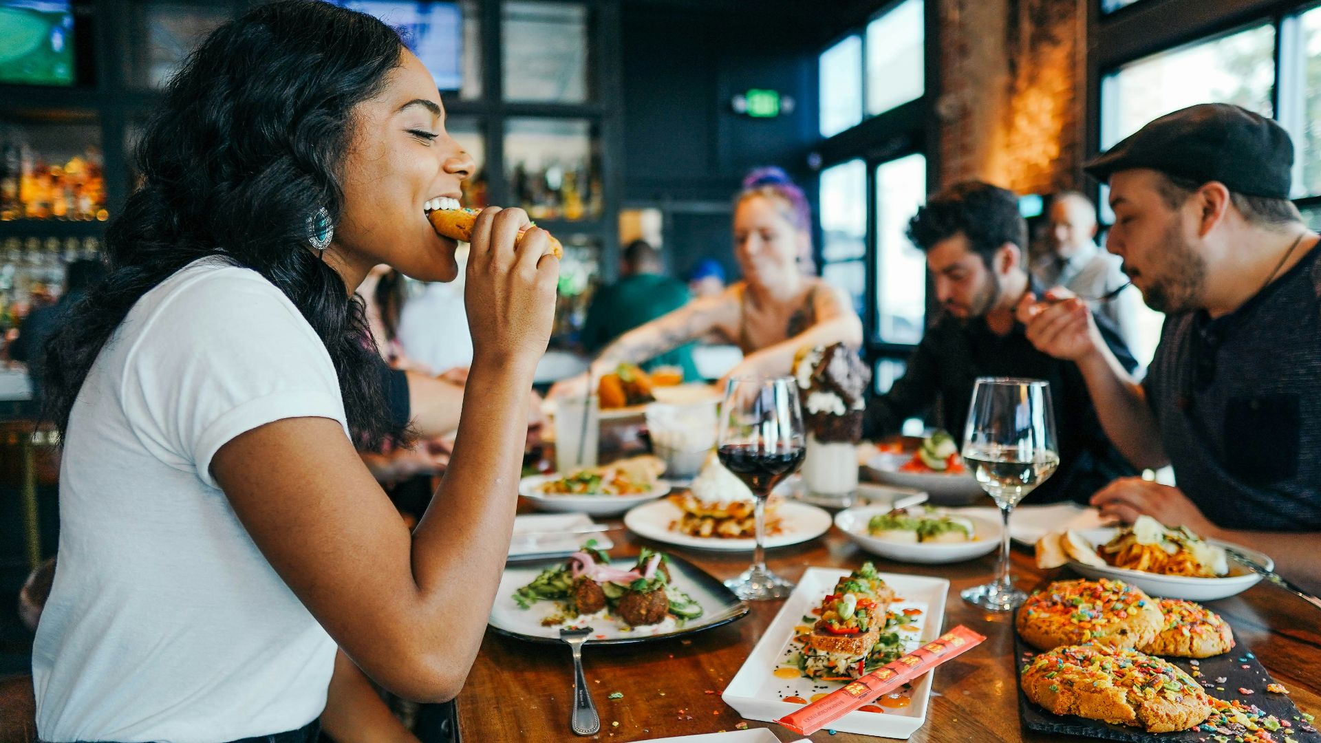 woman in white shirt eating
