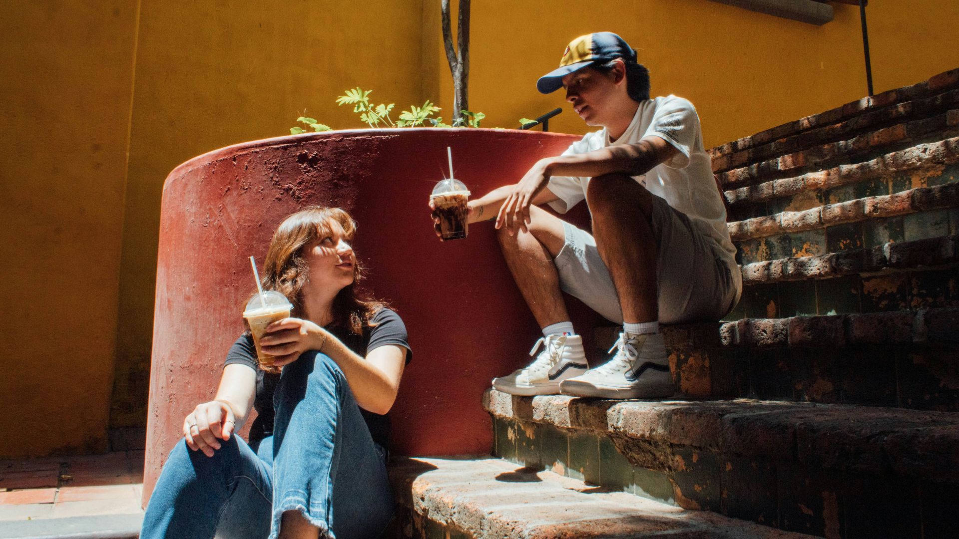 a man and a woman sitting on the steps of a building
