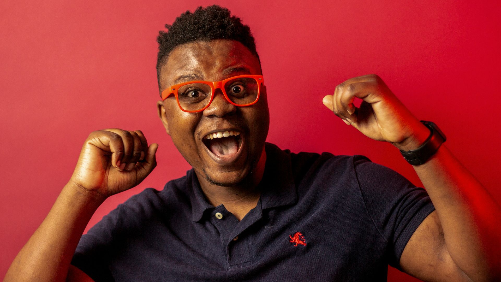man in black polo shirt wearing black framed eyeglasses