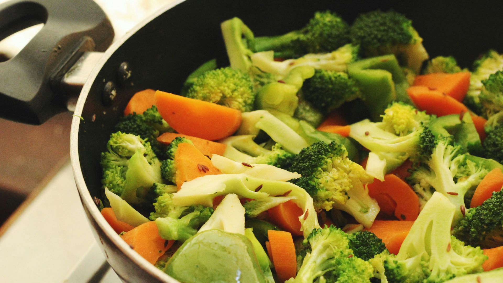 green and orange vegetable salad in white ceramic bowl