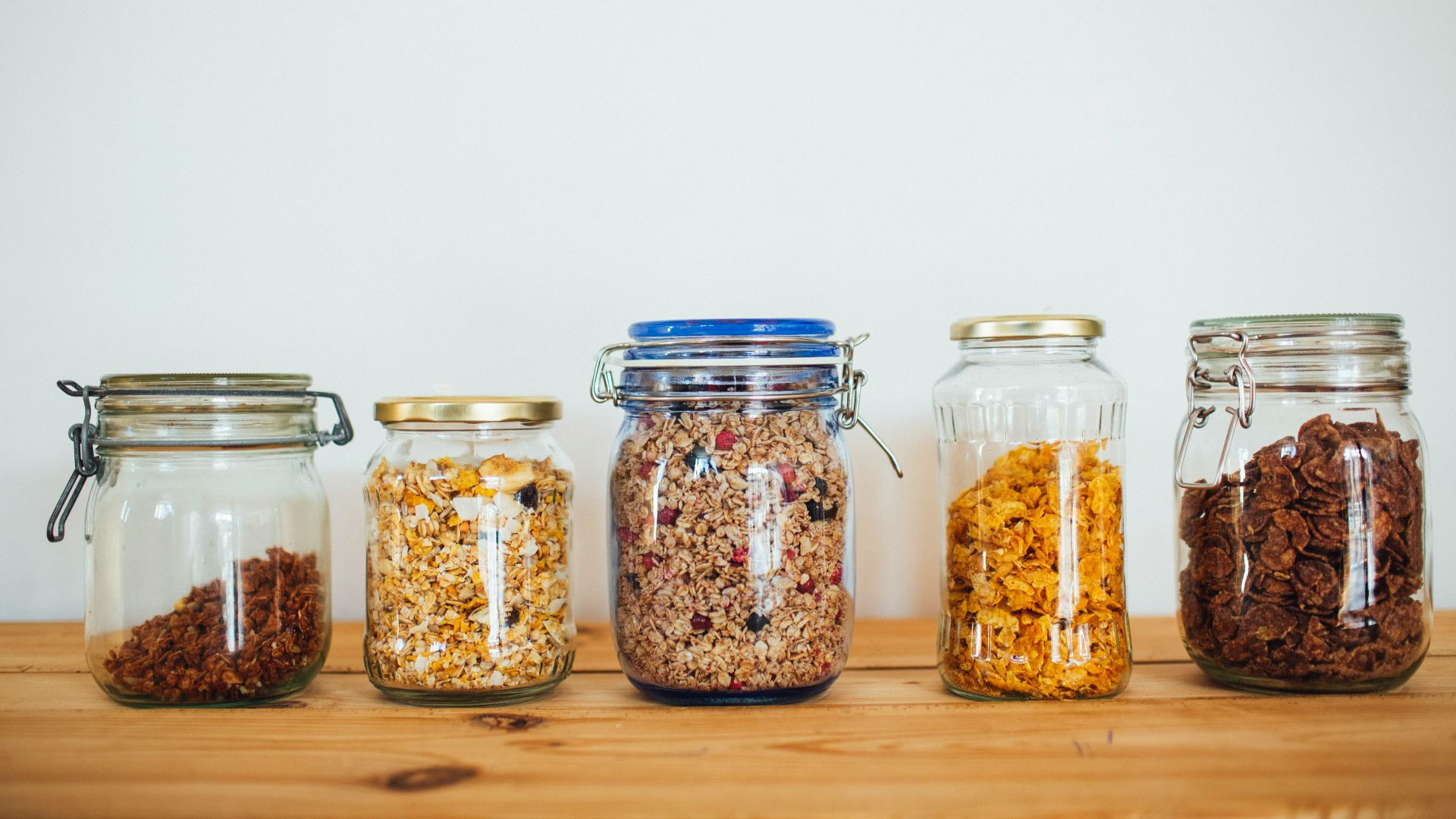 two clear glass jars with brown and black beads