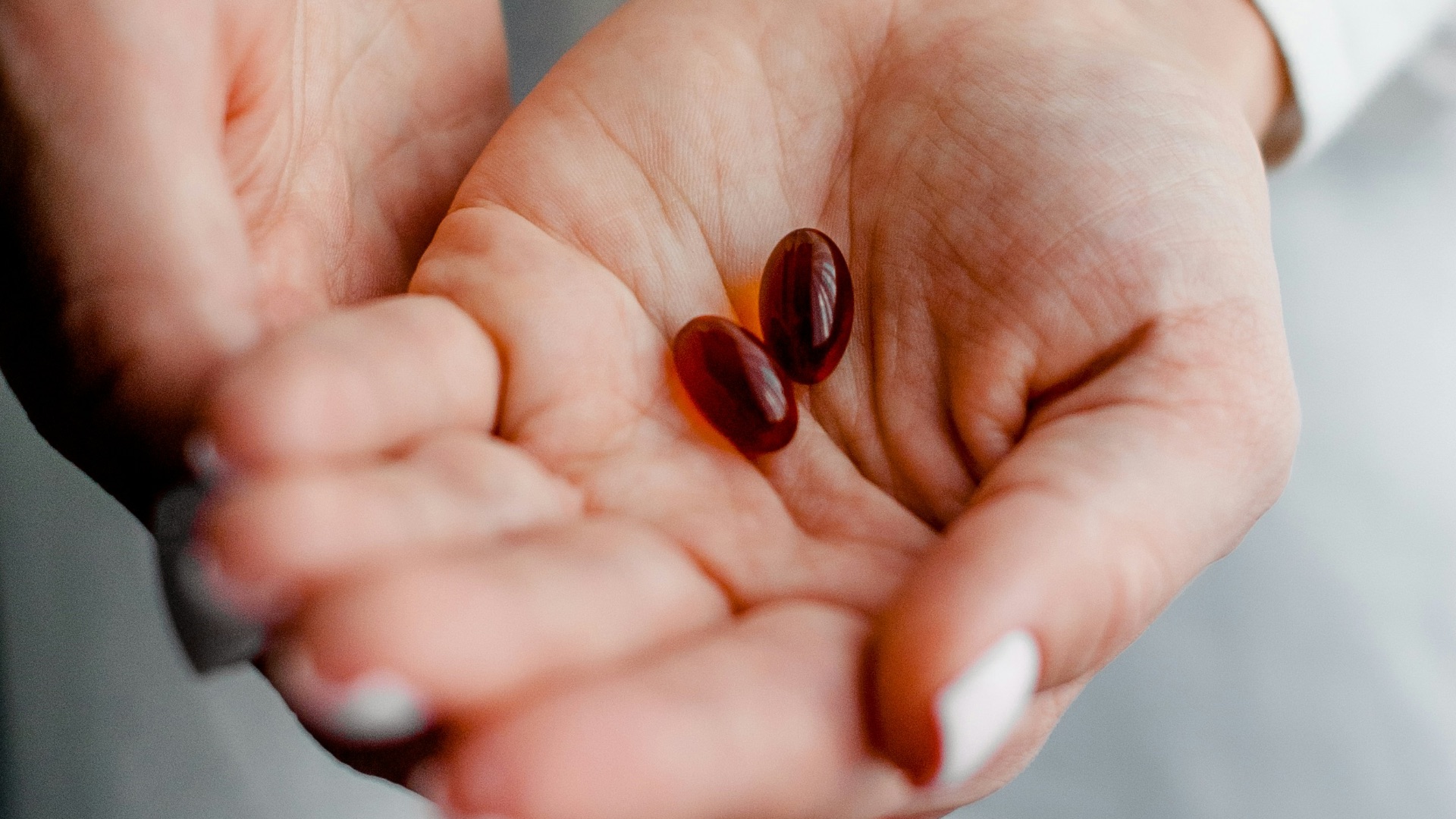 person holding brown and black round ornament