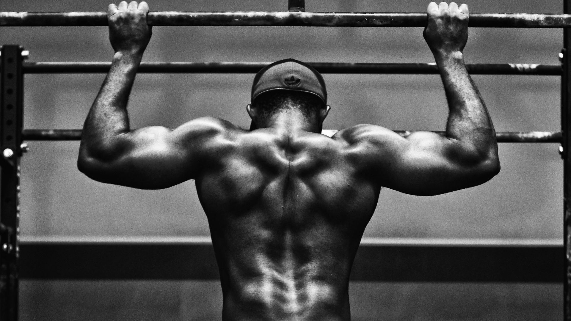 grayscale photo of man working out