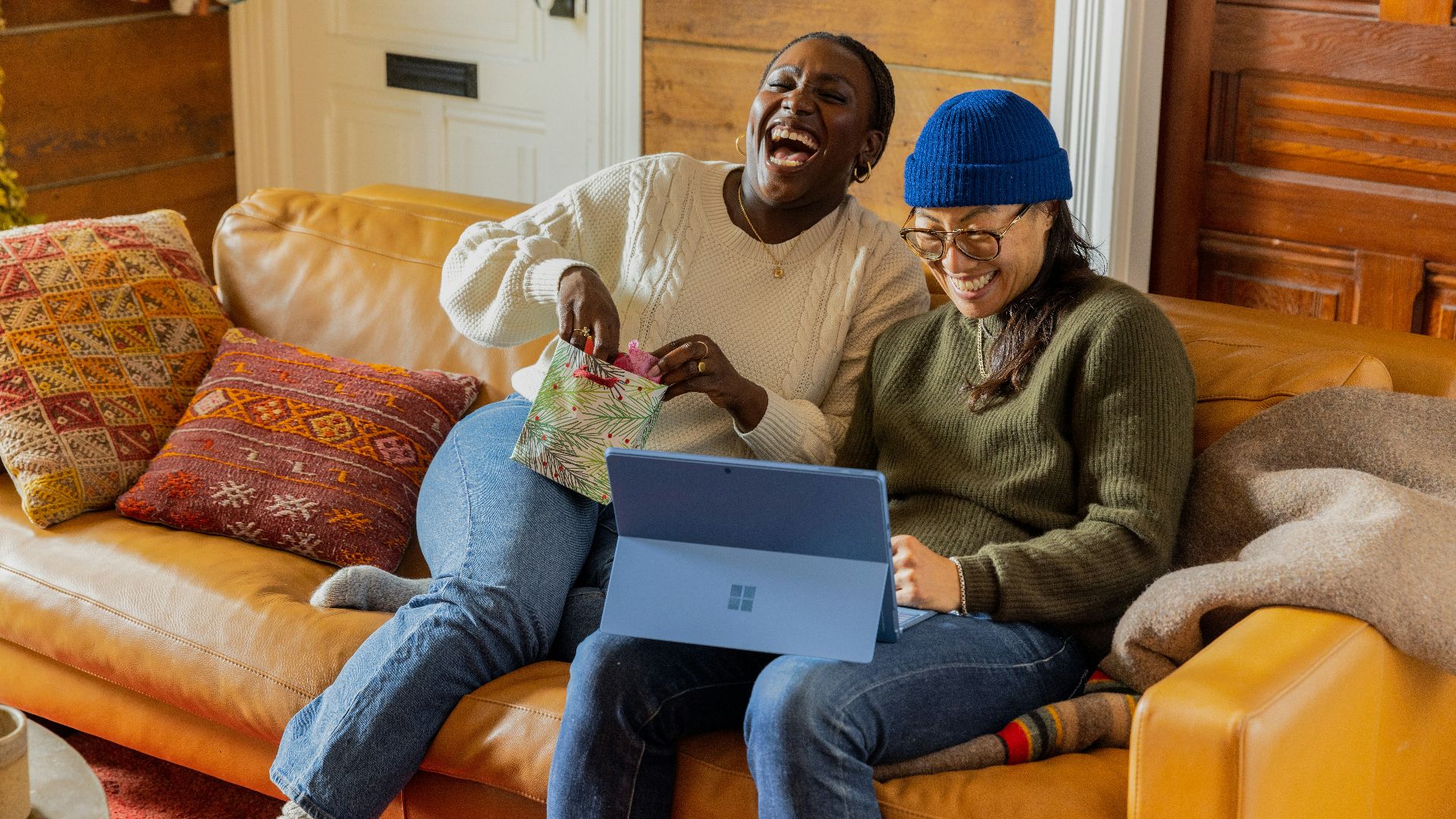 a person sitting on a couch with a laptop