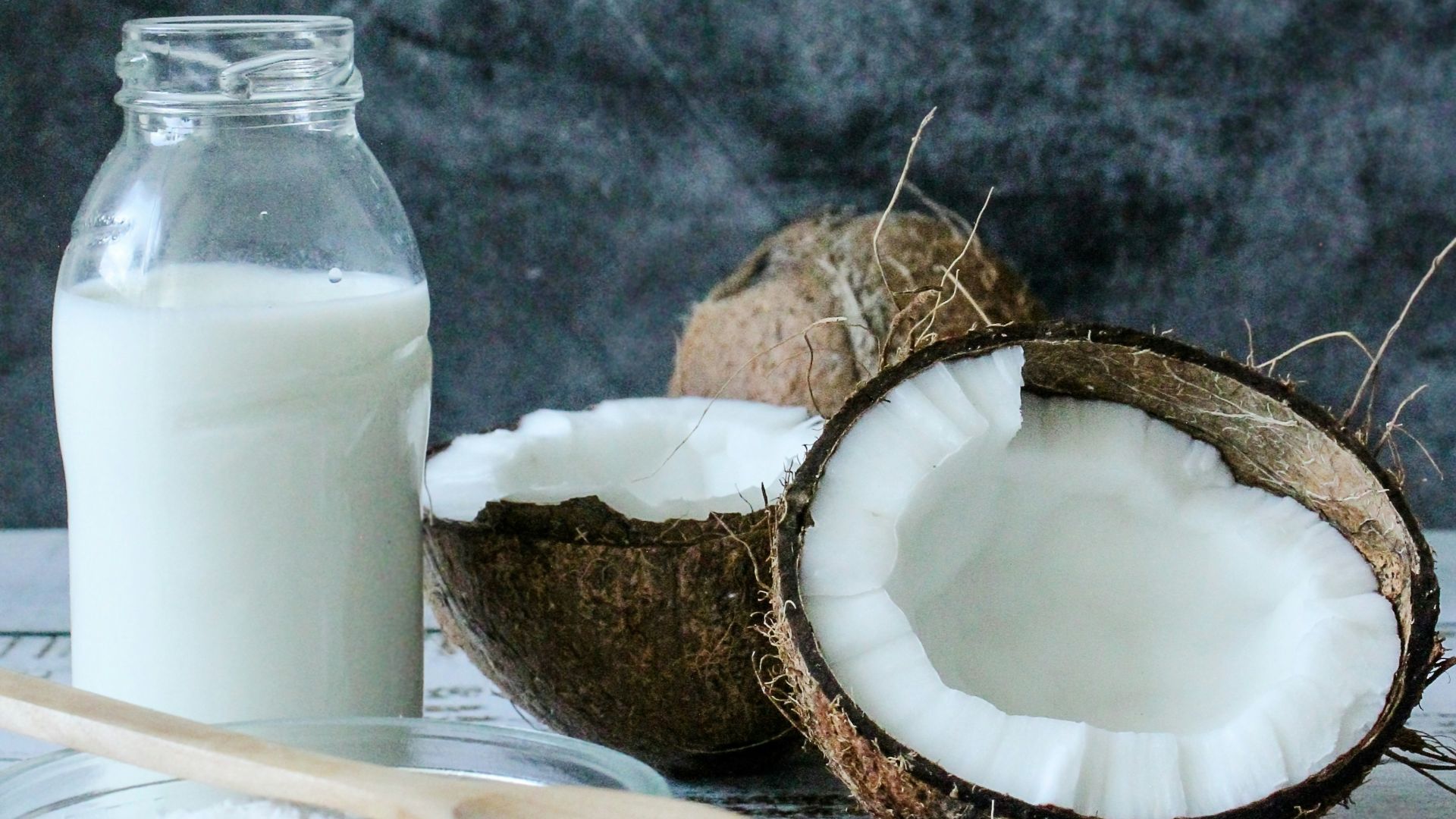 white pillar candle on brown wooden coaster