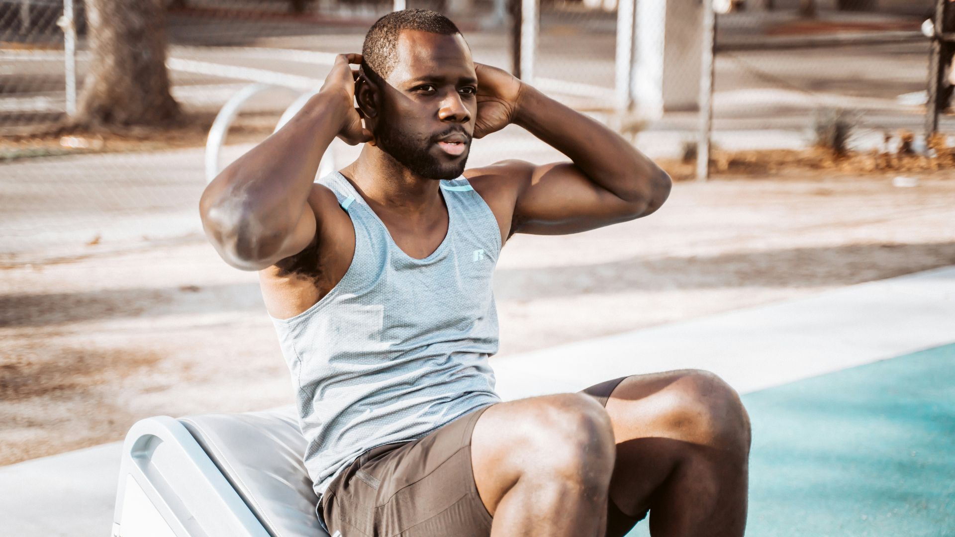 woman in white tank top and gray shorts sitting on white car