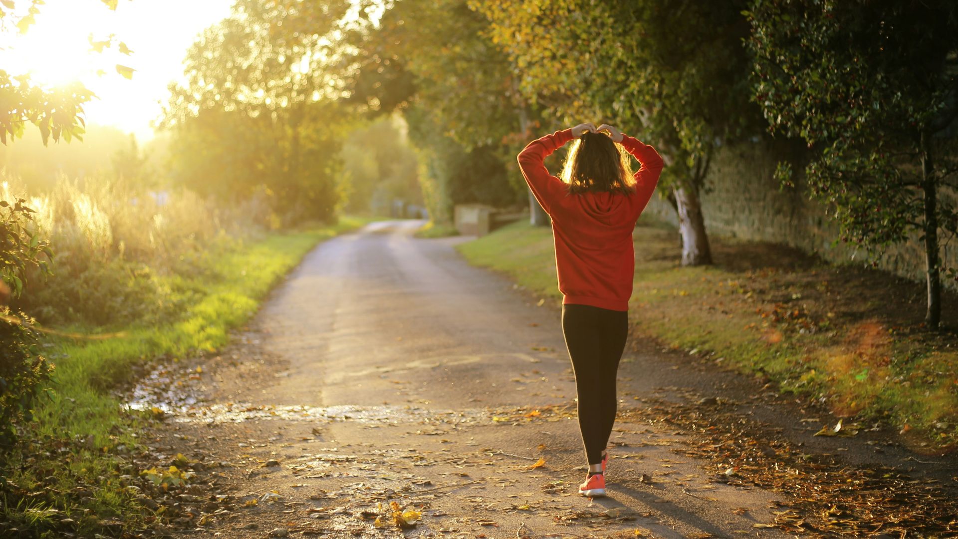 woman walking on pathway during daytime