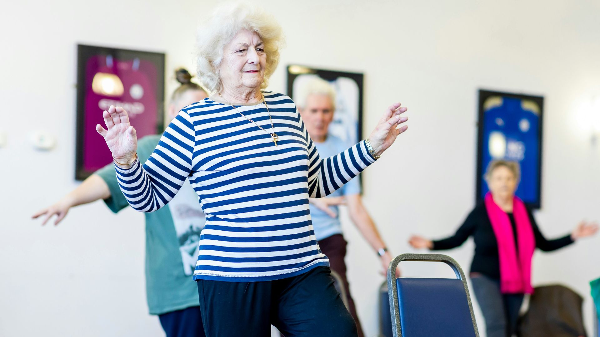 a group of older women dancing in a room