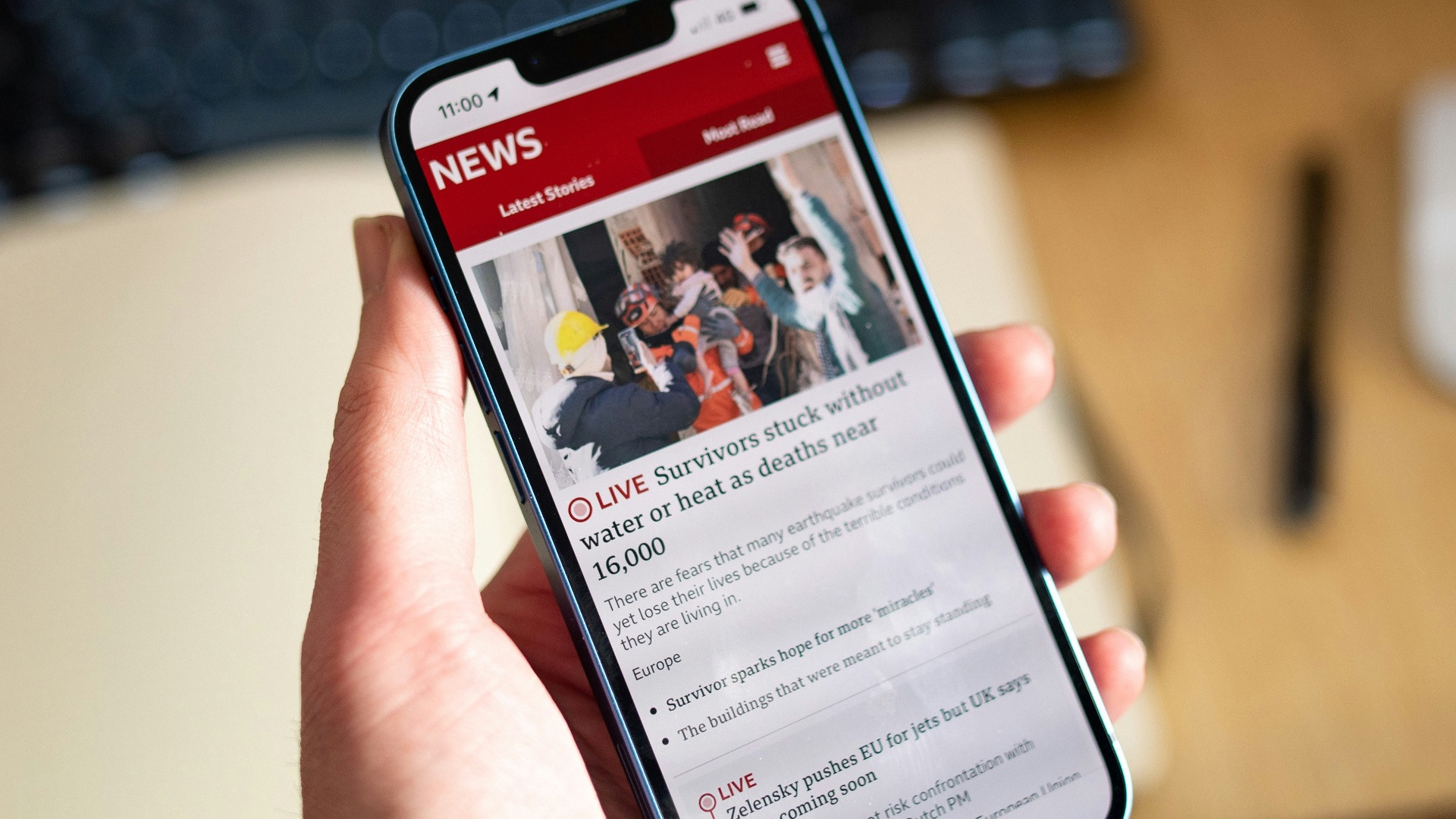 a person holding a cell phone in their hand