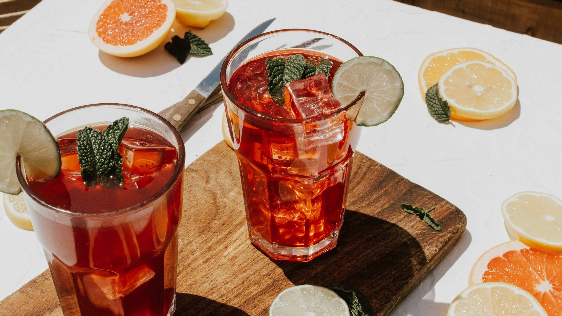 two clear drinking glasses with filled red liquid