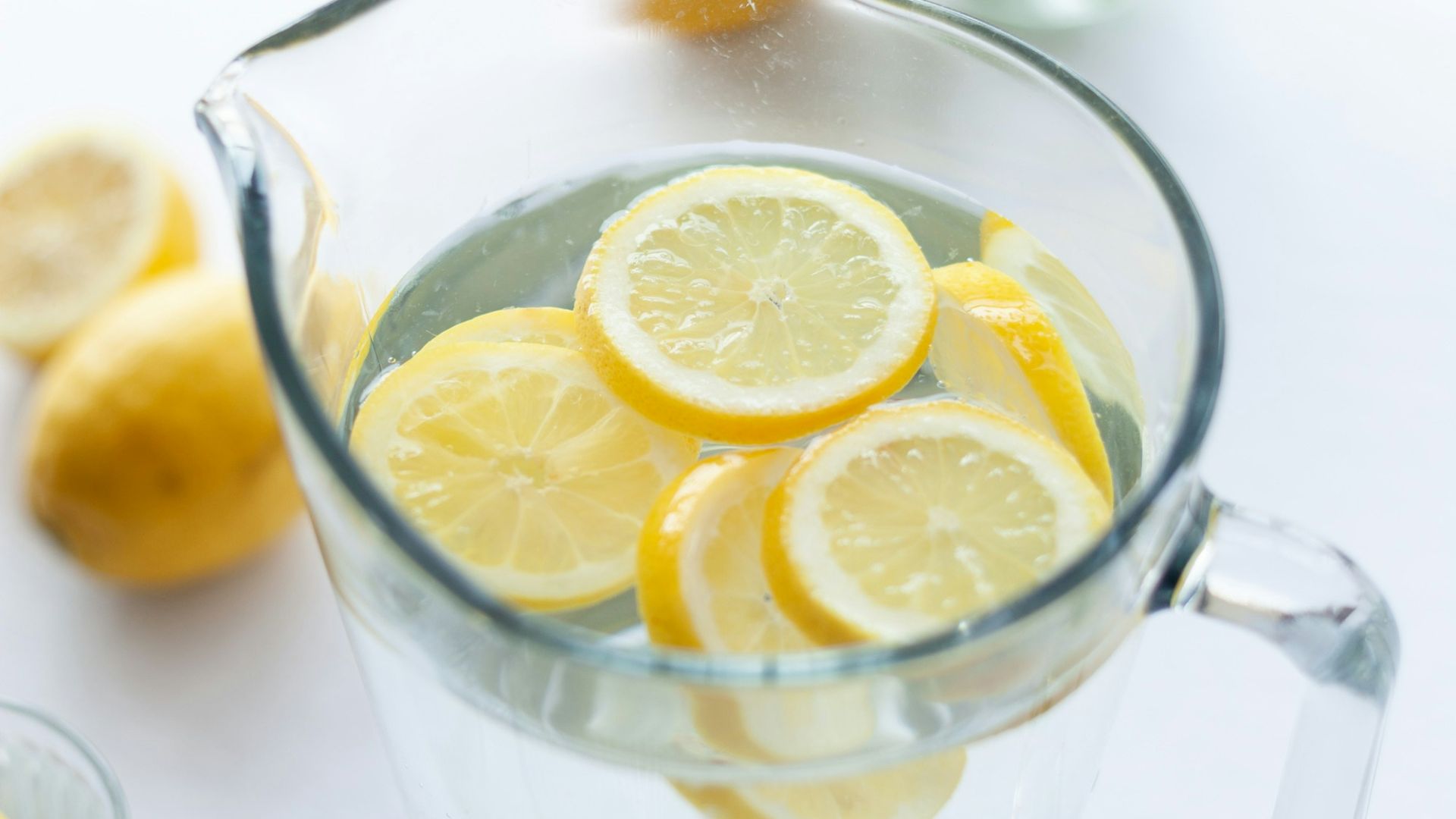 slices of lemons in clear pitcher filled with water
