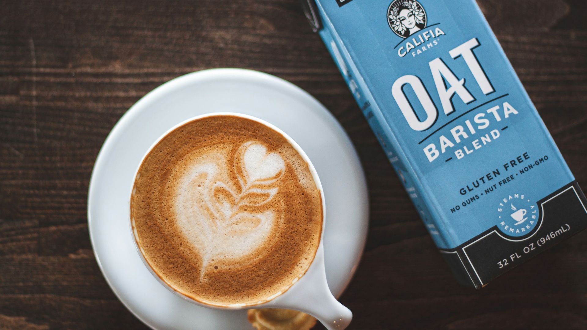 cup of latte beside oat barista box