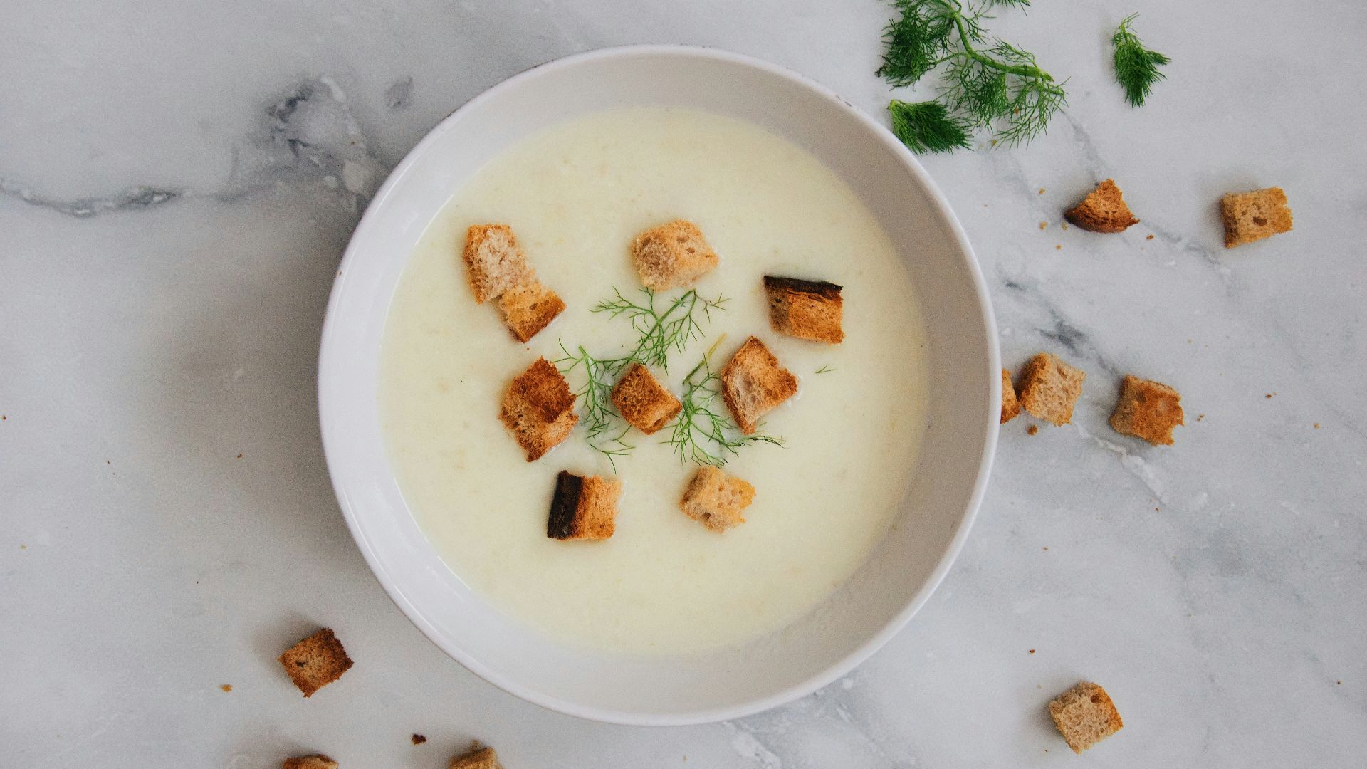 soup with green leaf on white ceramic bowl